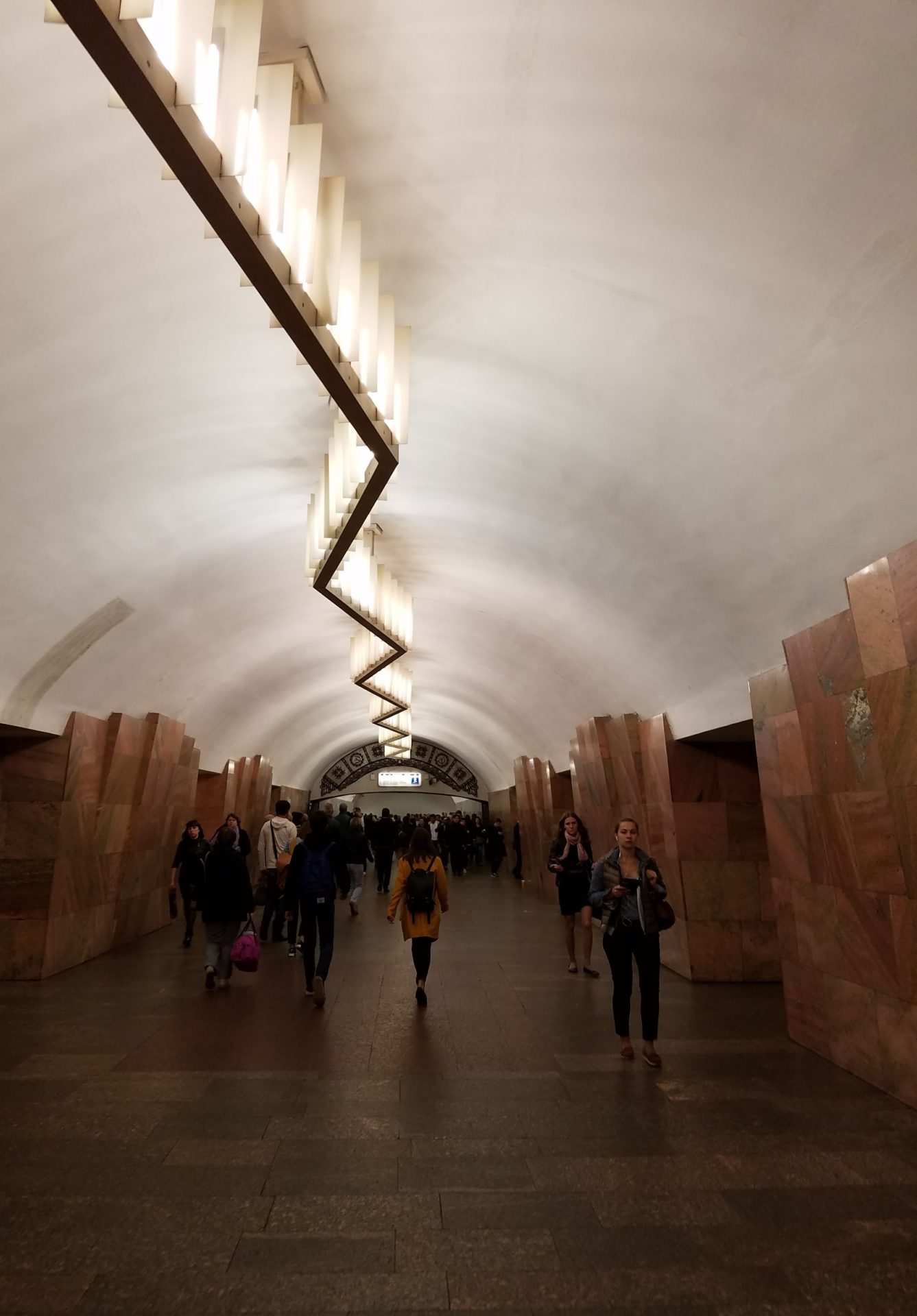 a group of people walking in a tunnel