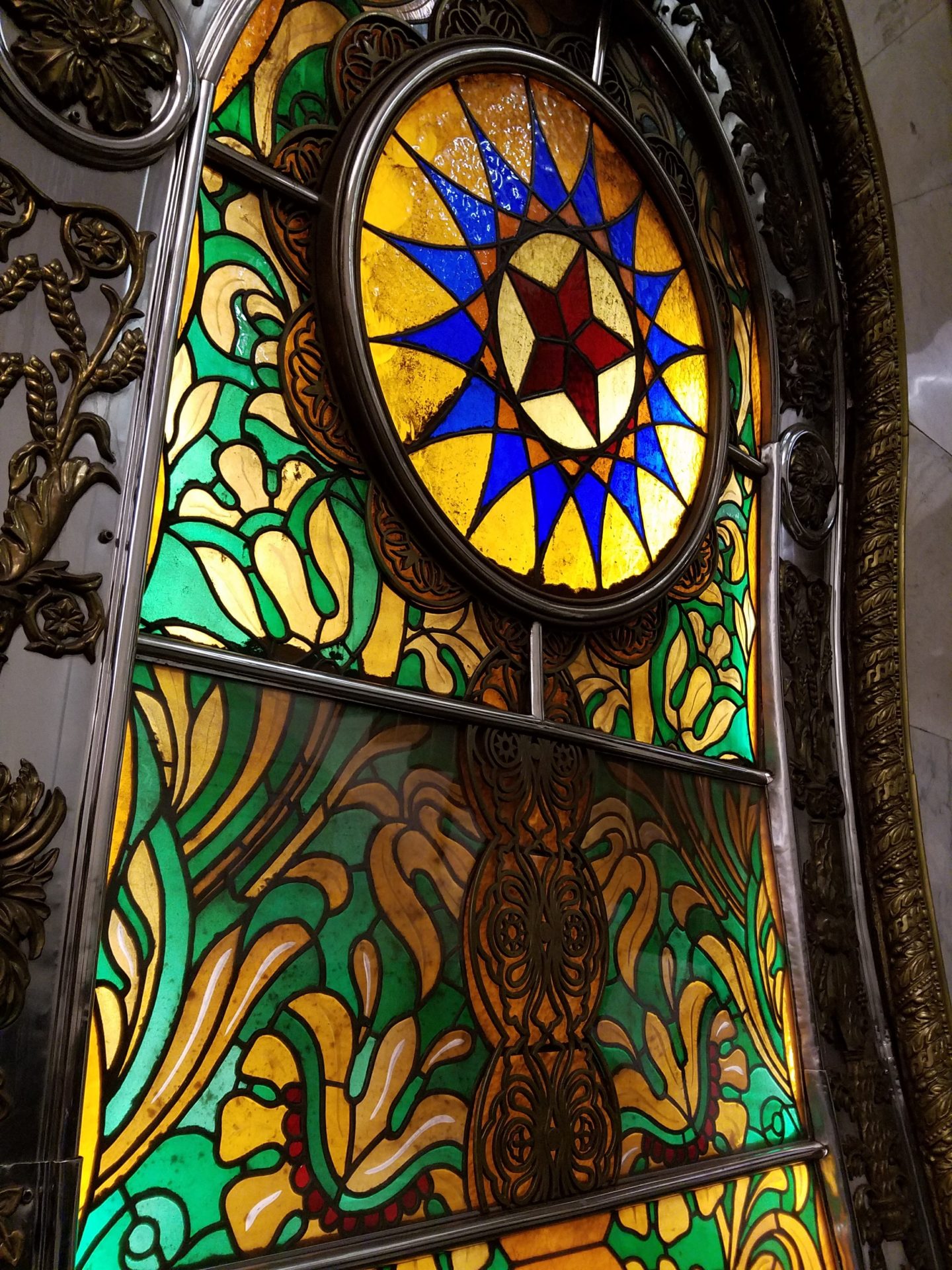 a stained glass window with a star in the middle