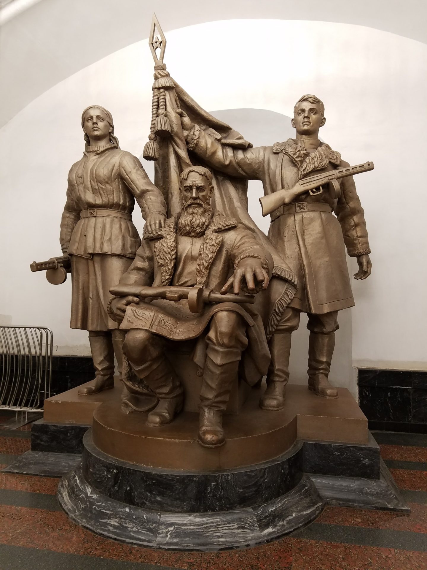 a statue of a man with a beard and a man holding a gun