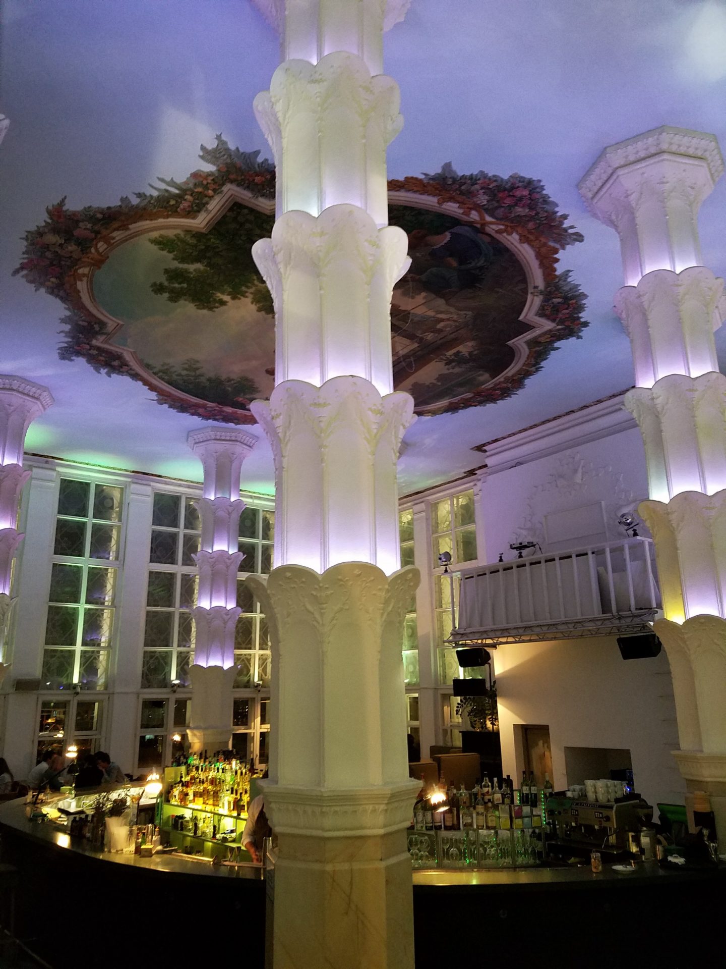 a room with columns and a bar