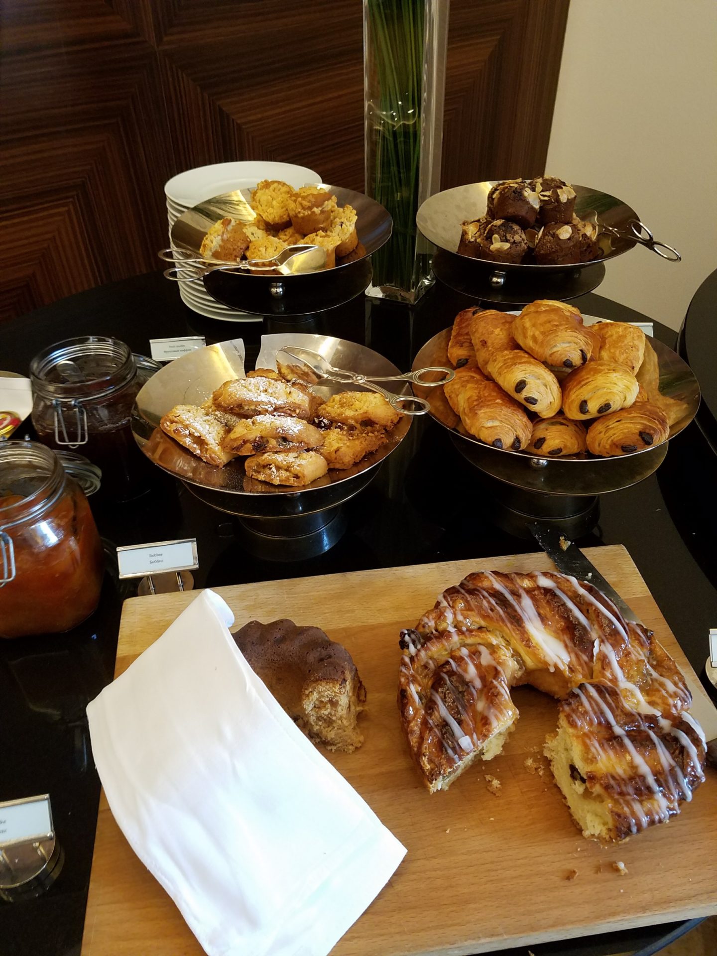 a table with plates of pastries and pastries