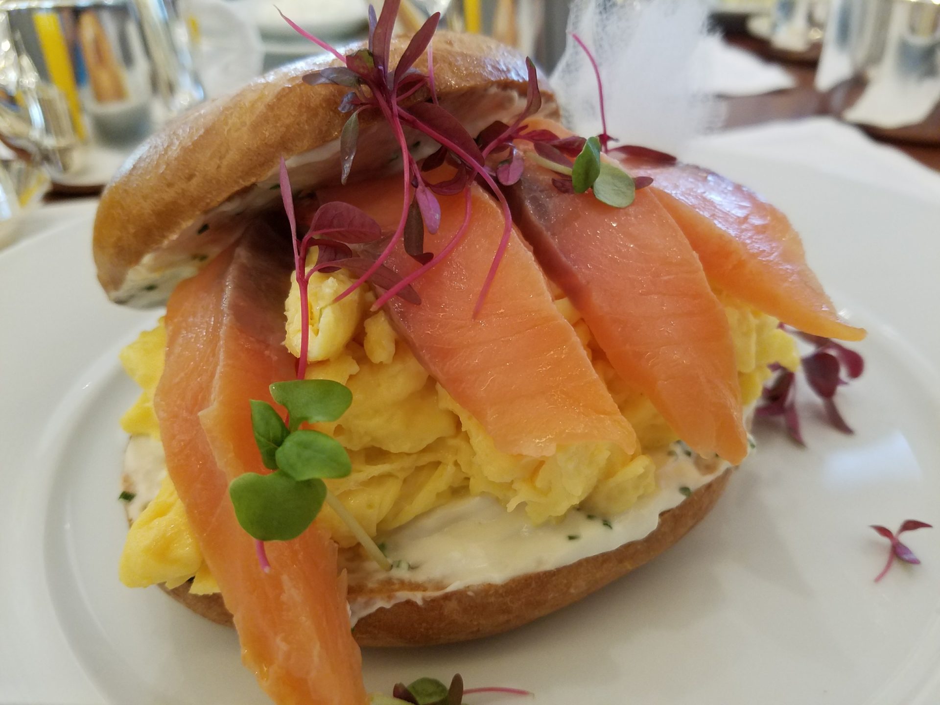 a sandwich with eggs and fish on top