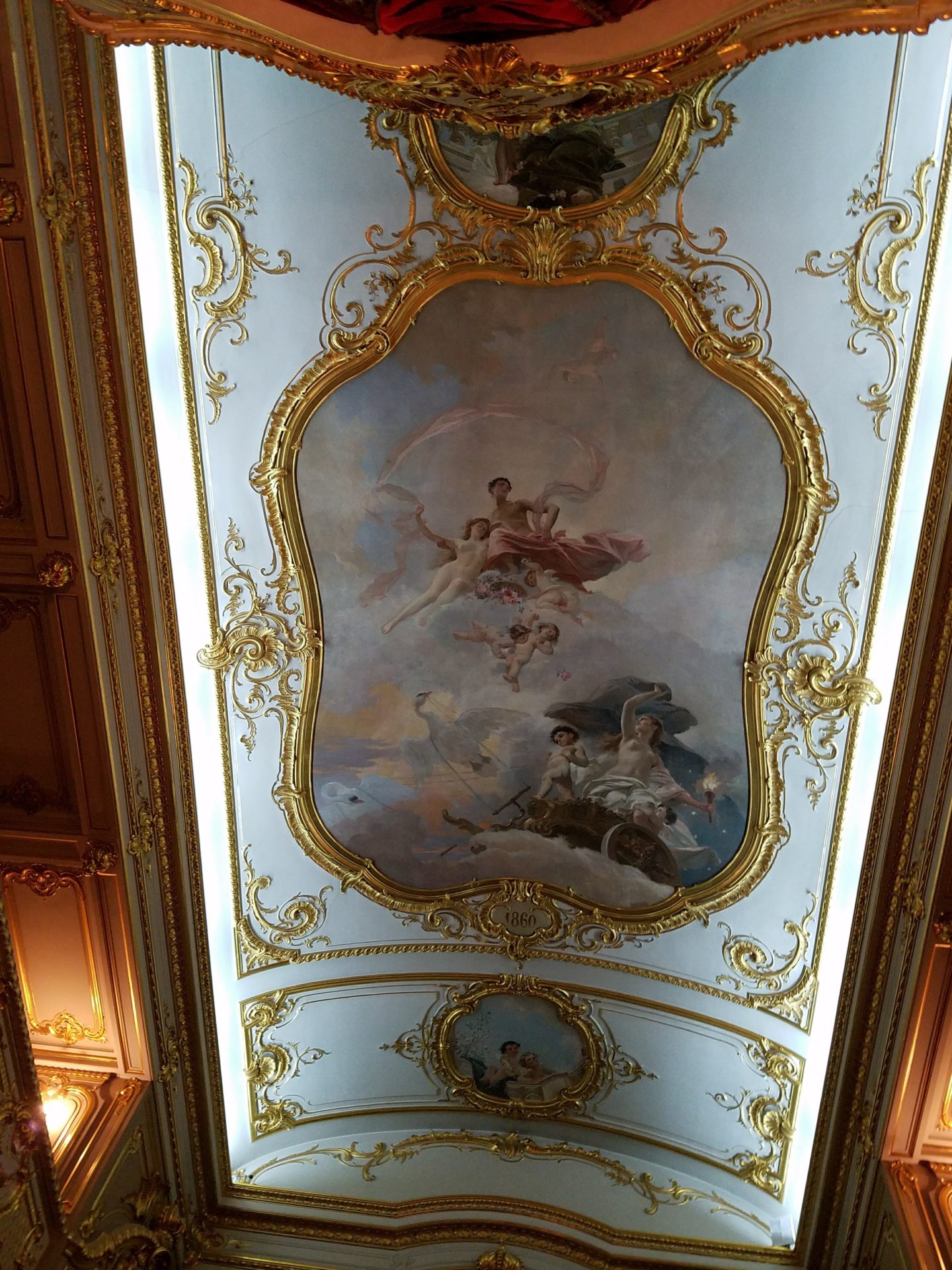 a ceiling with gold trim and paintings