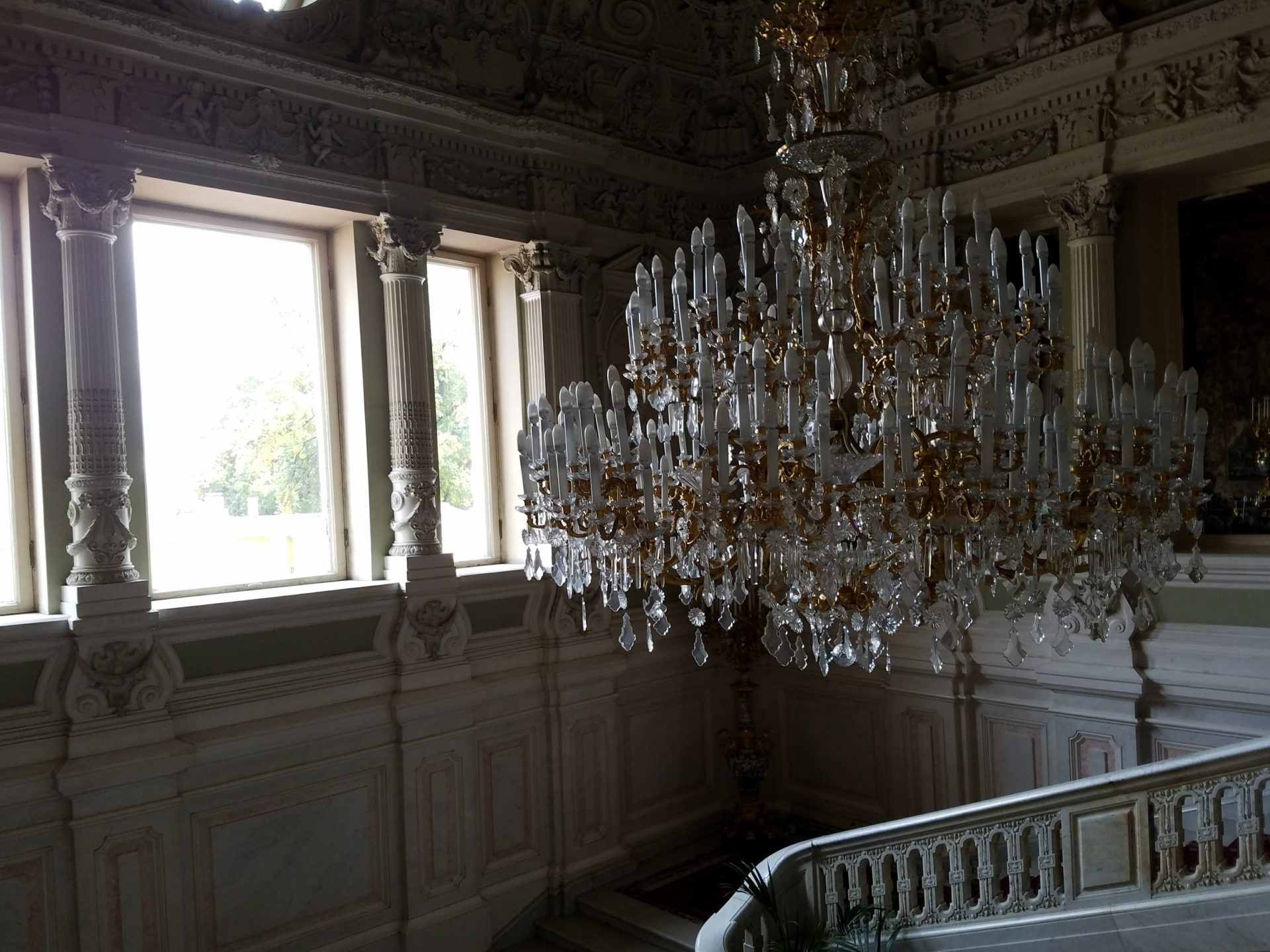 a chandelier in a room with windows