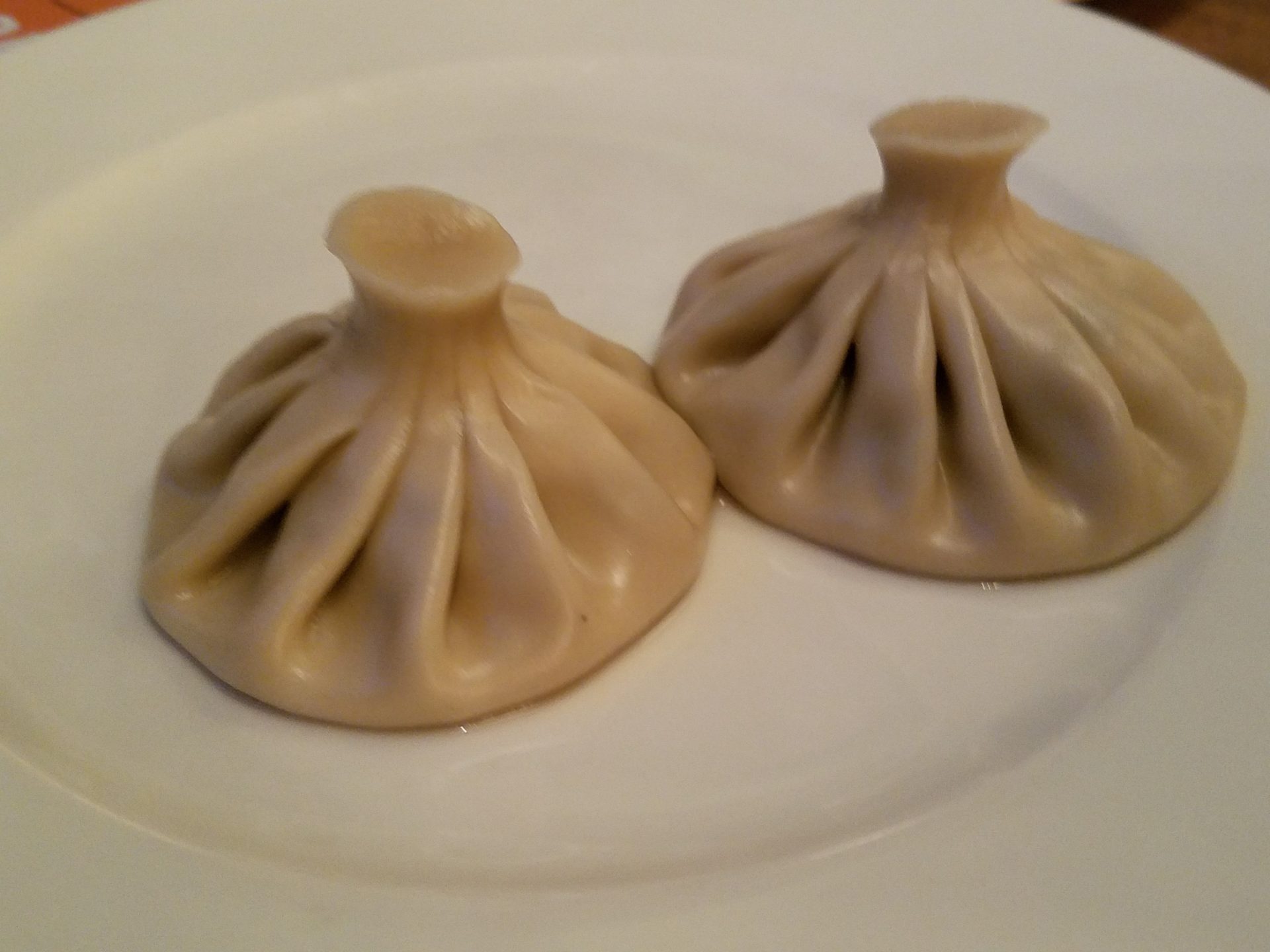 a pair of dumplings on a plate