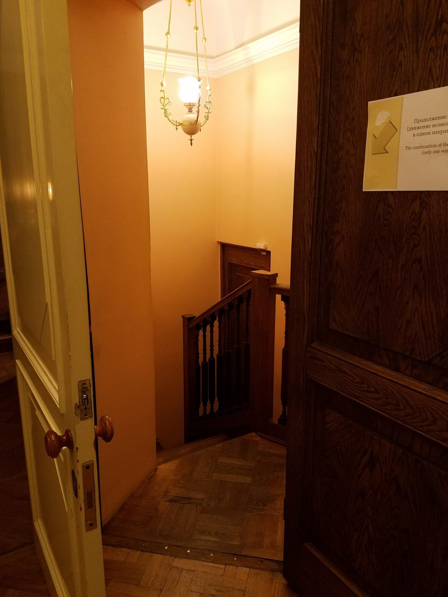 a door with a light fixture and a staircase
