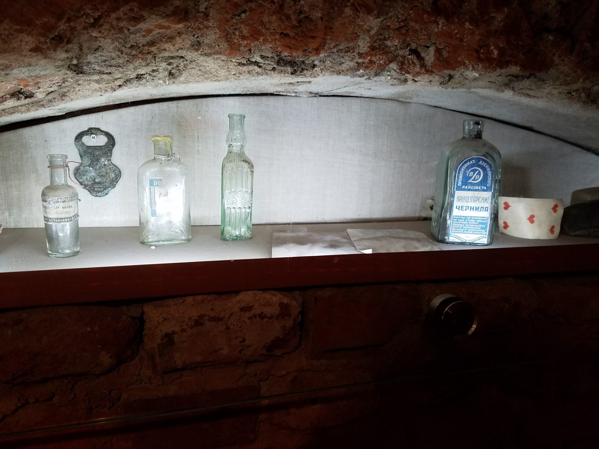 a shelf with bottles and other objects