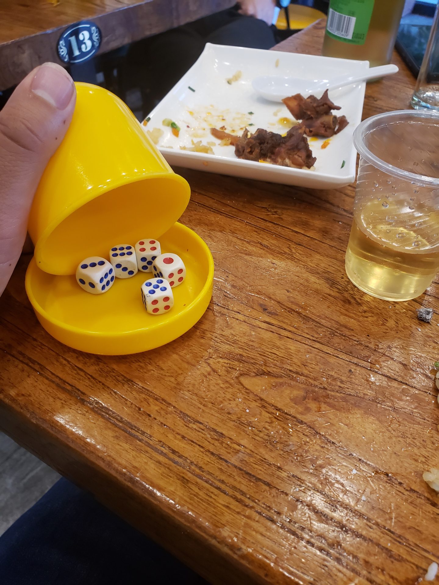 a yellow container with dice on it