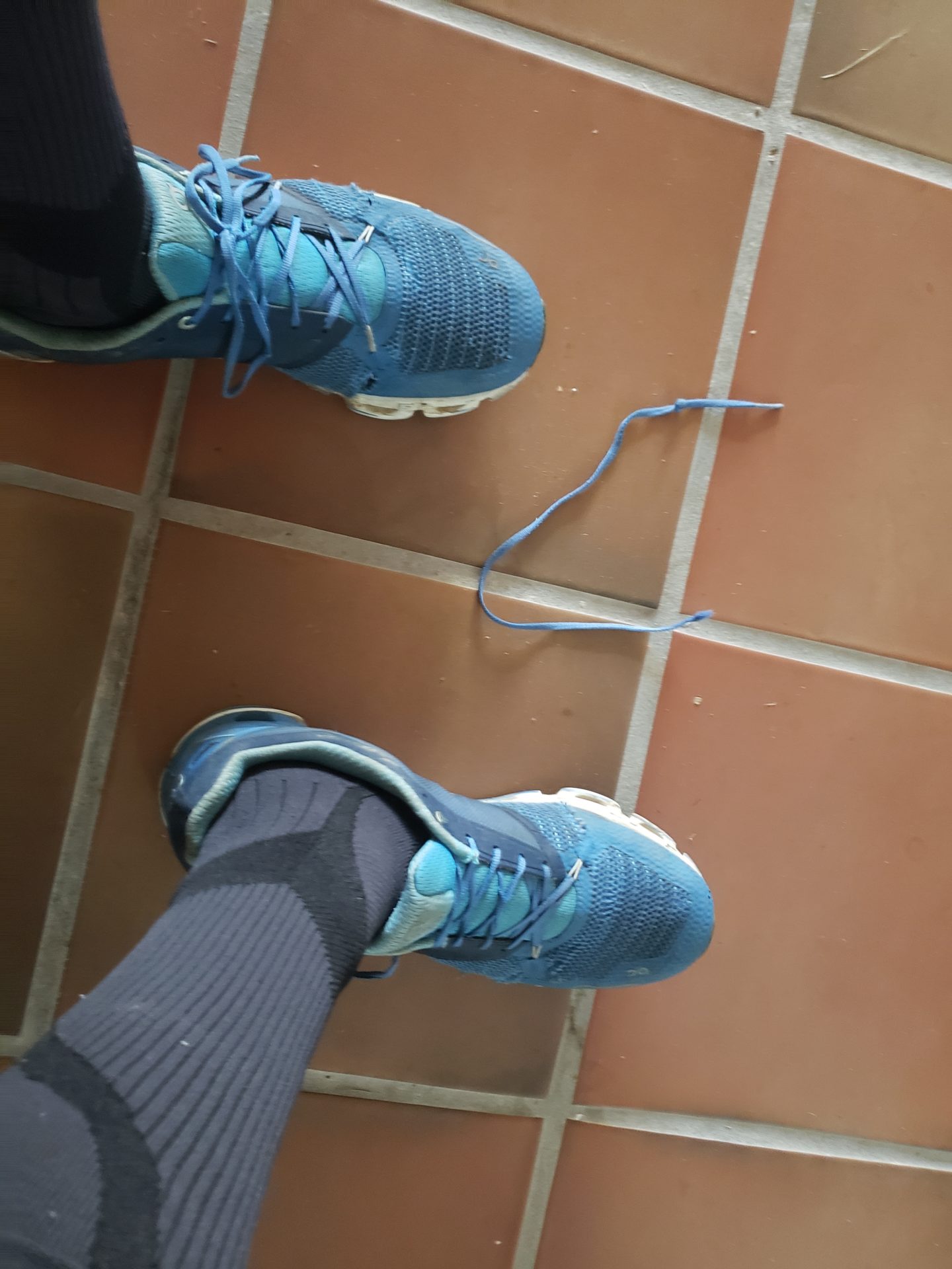a person's feet with blue shoes and socks