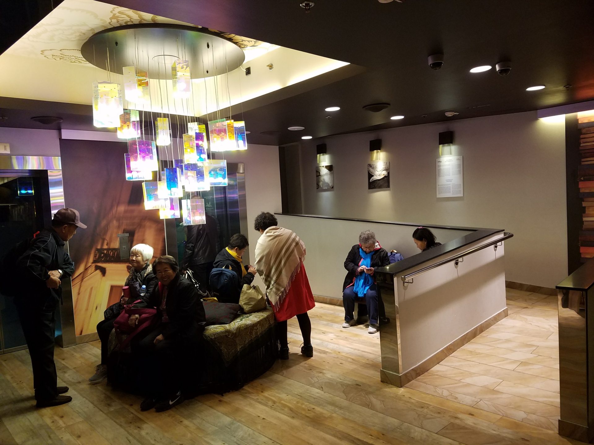 a group of people sitting in a lobby