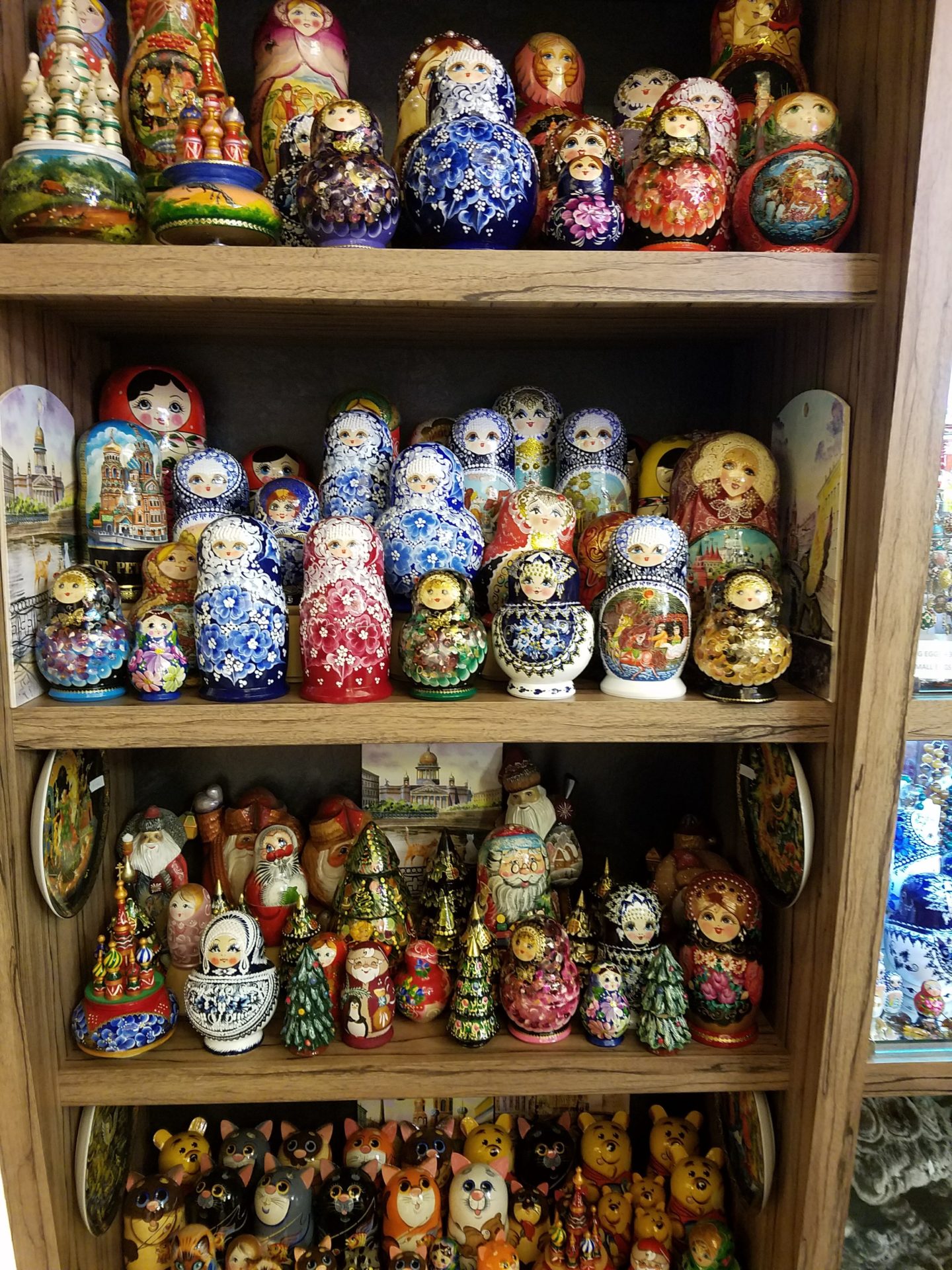 a shelf full of colorful nesting dolls