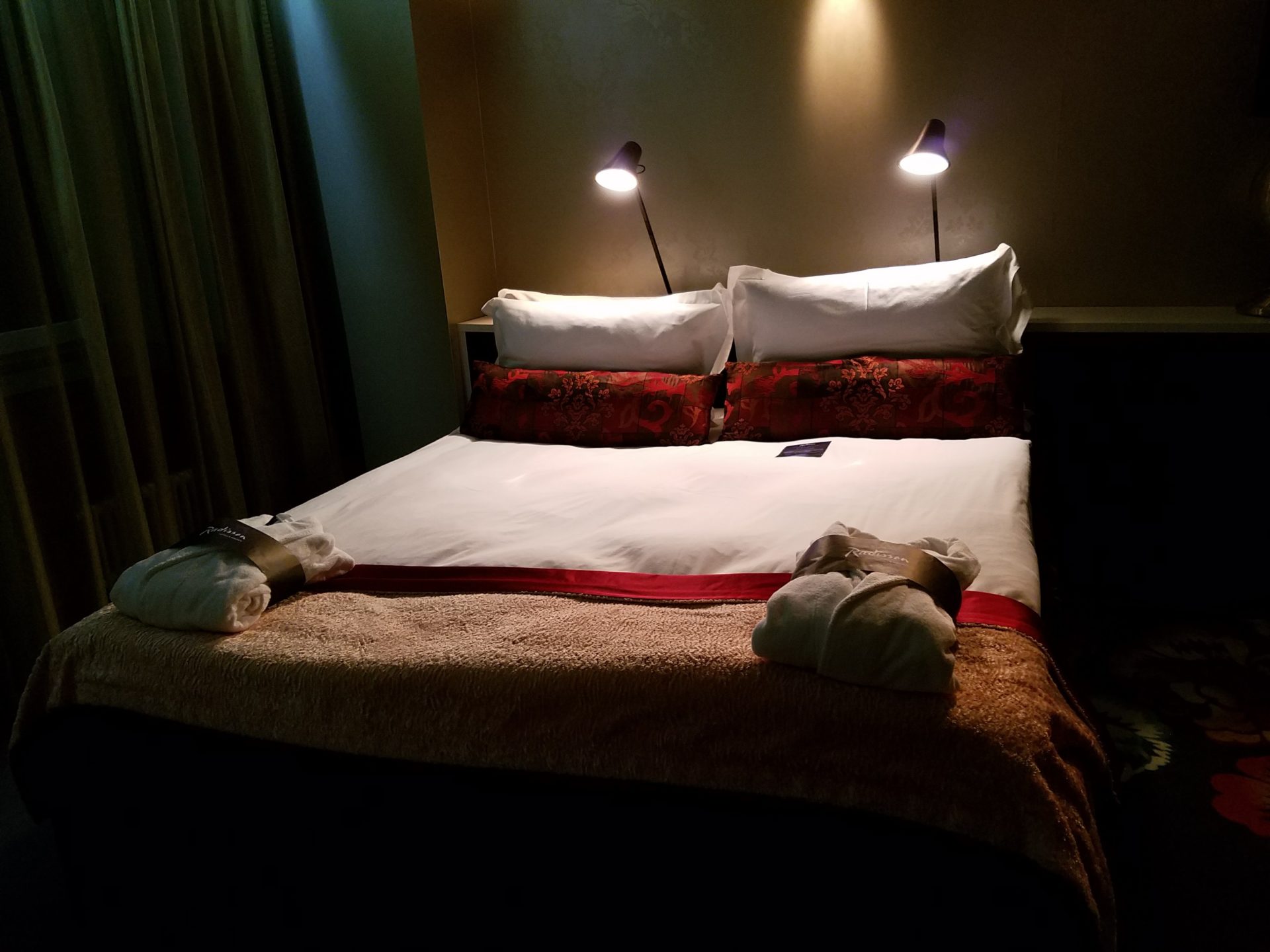 a bed with two lamps on it