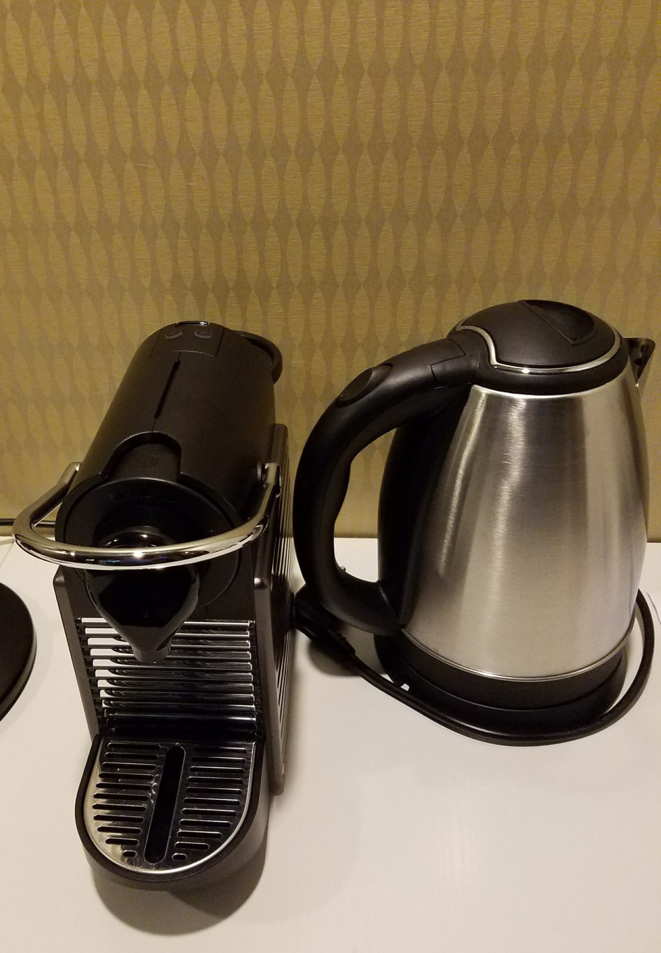a coffee maker next to a coffee pot