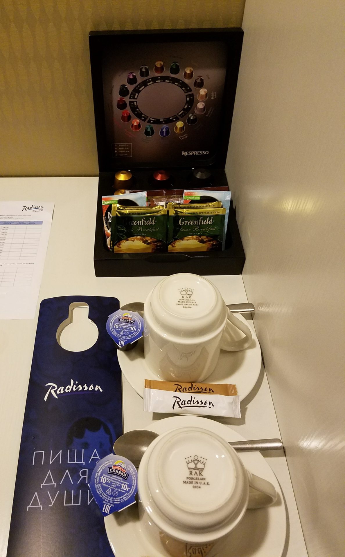 a coffee mug and tea bag on a plate