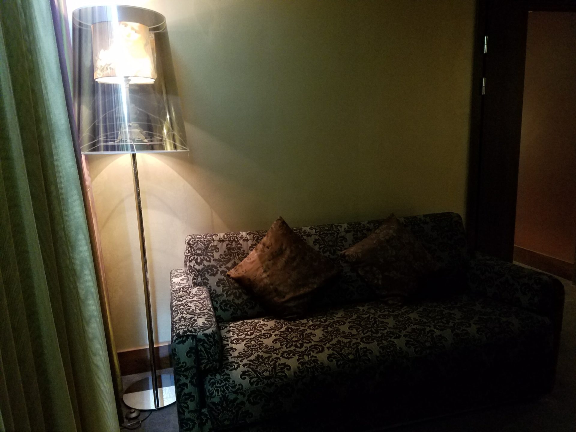 a couch with a lamp in a room