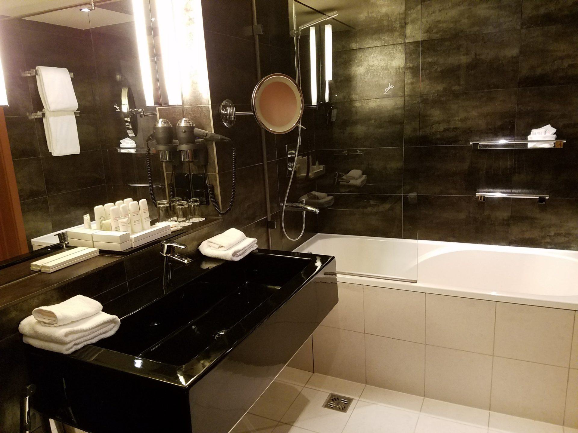 a bathroom with a black sink and bathtub