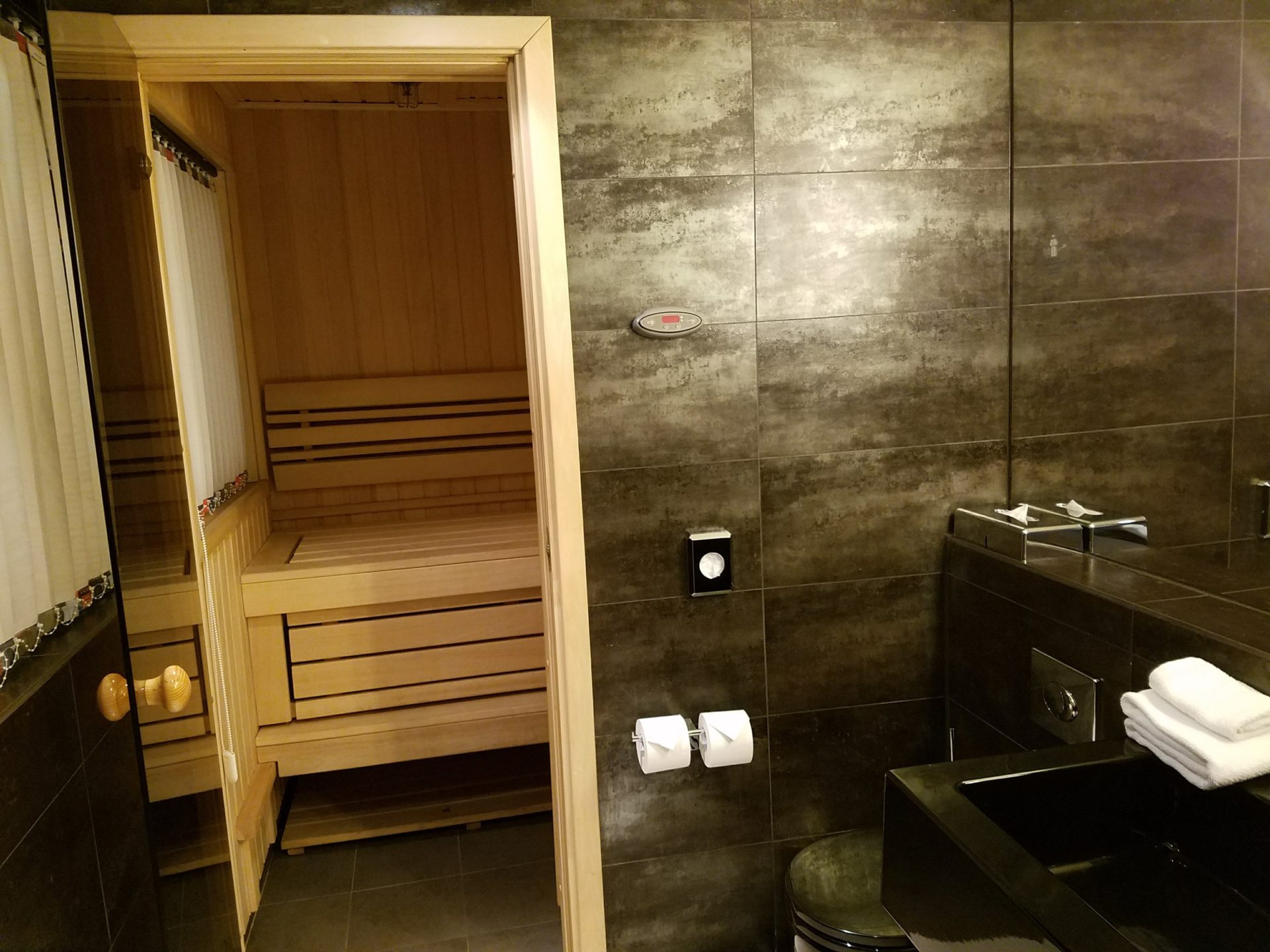 a bathroom with a wooden sauna