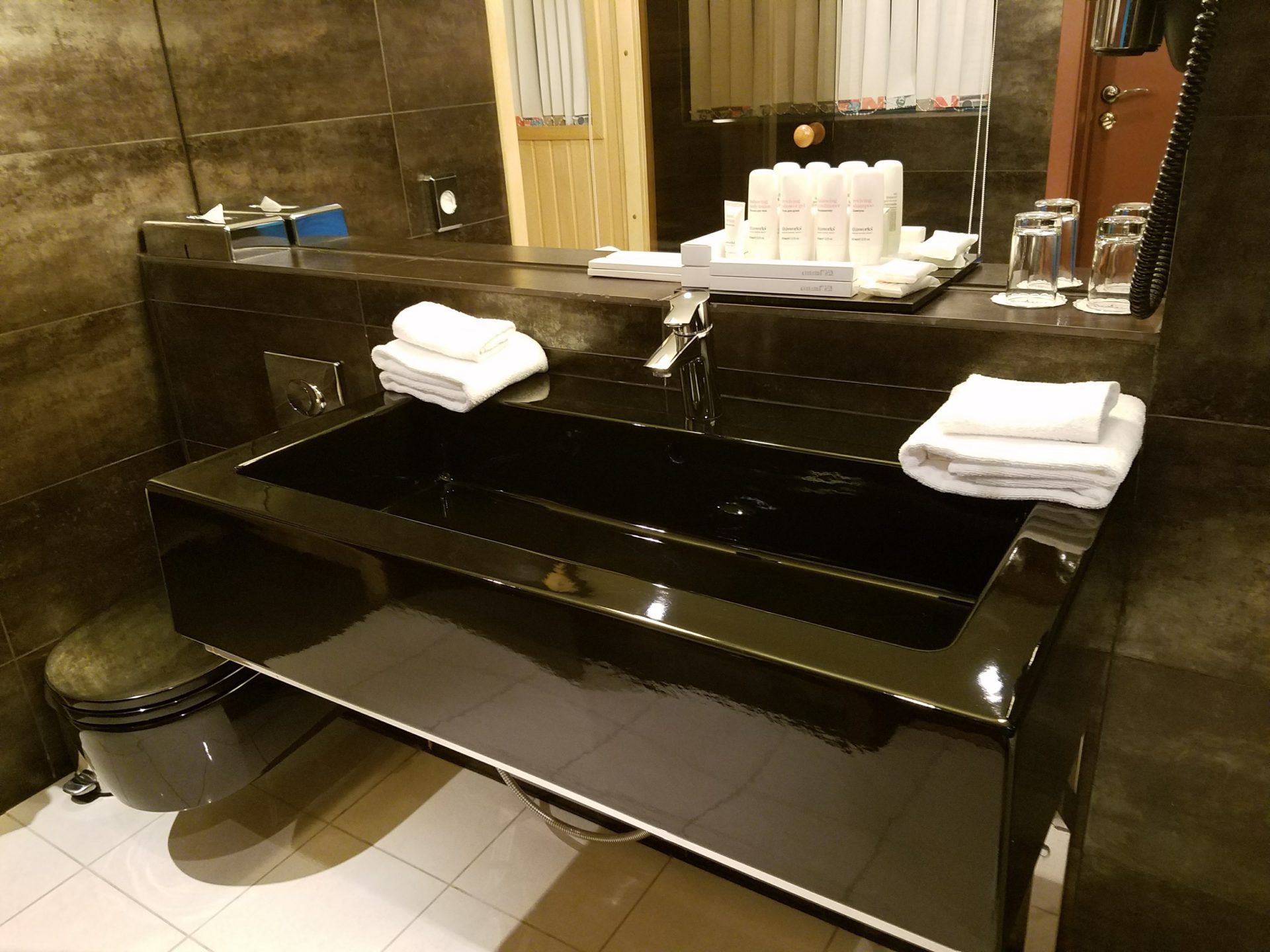 a black sink with white towels on top