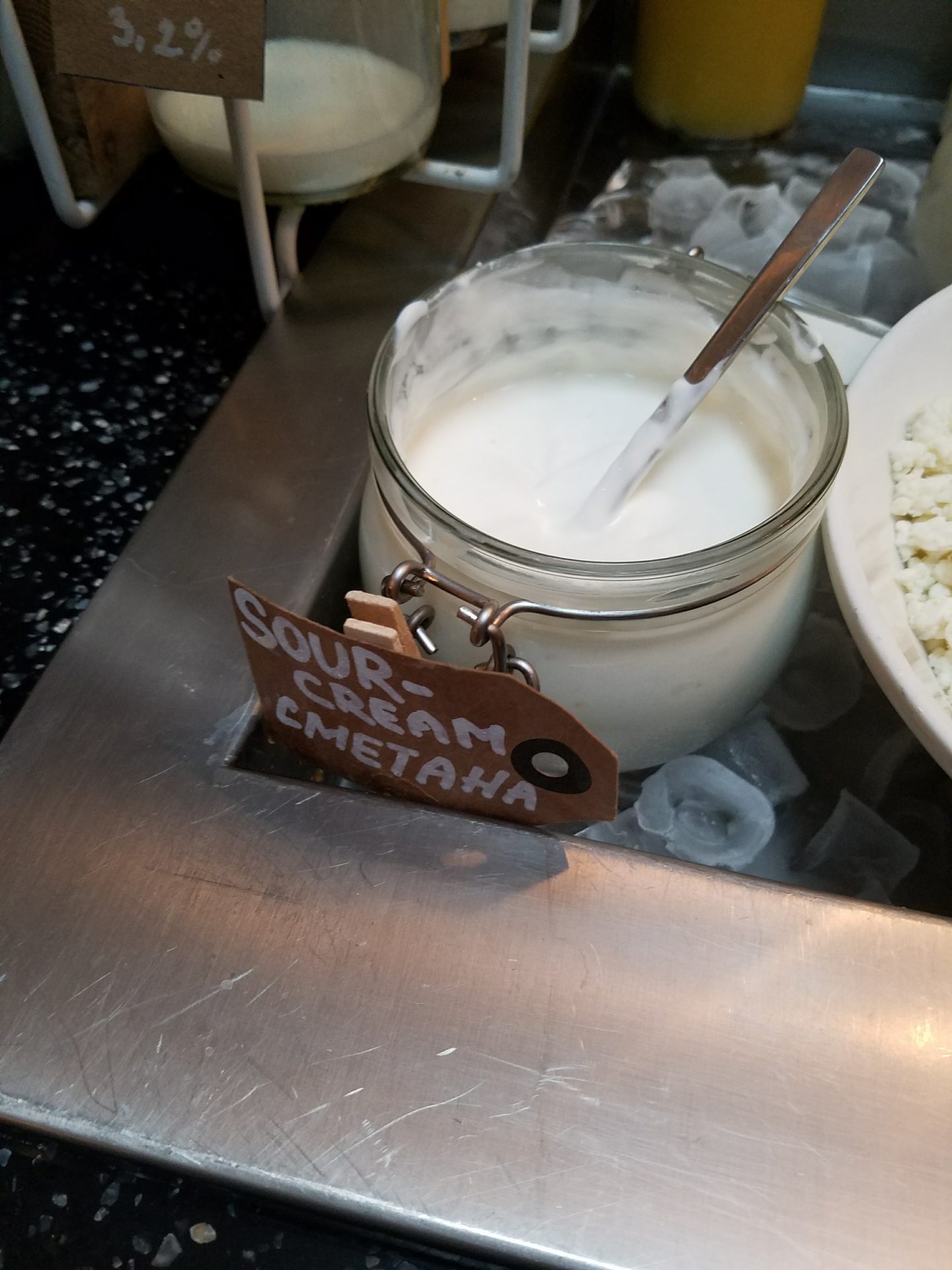 a jar of sour cream and a spoon