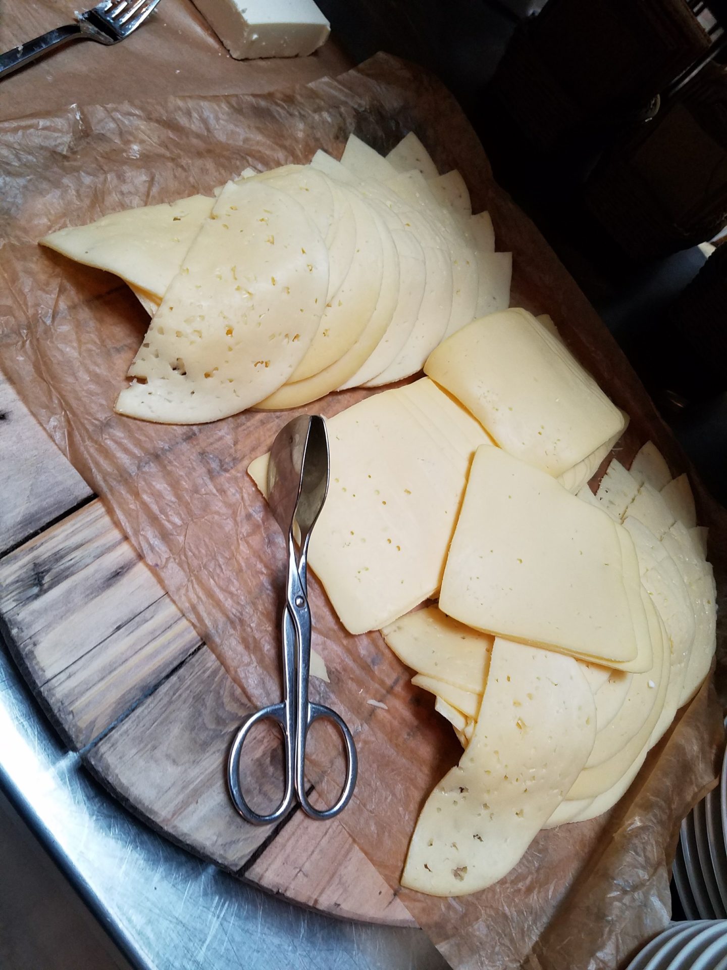 a cheese and scissors on a tray