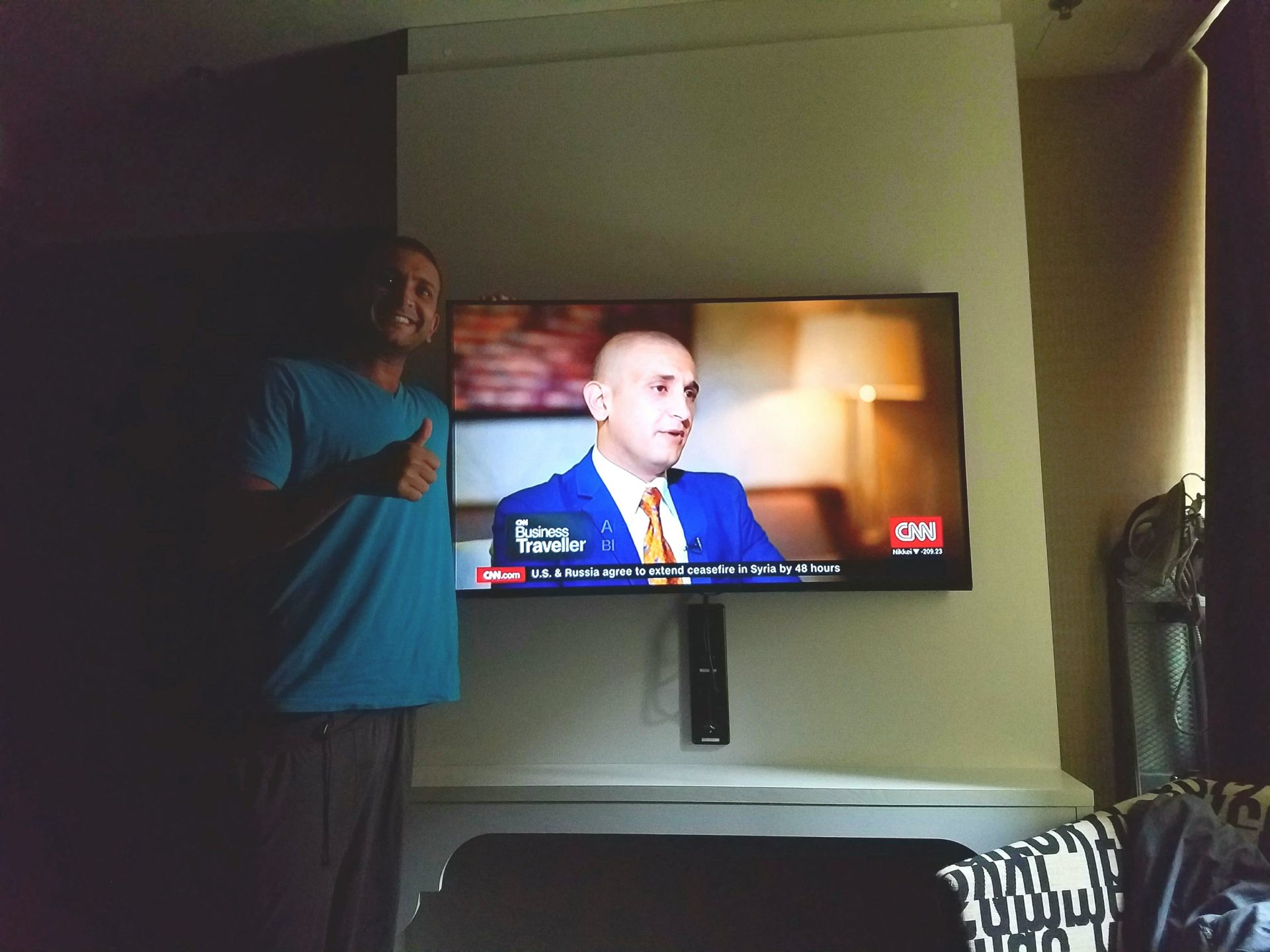 a man standing in front of a television