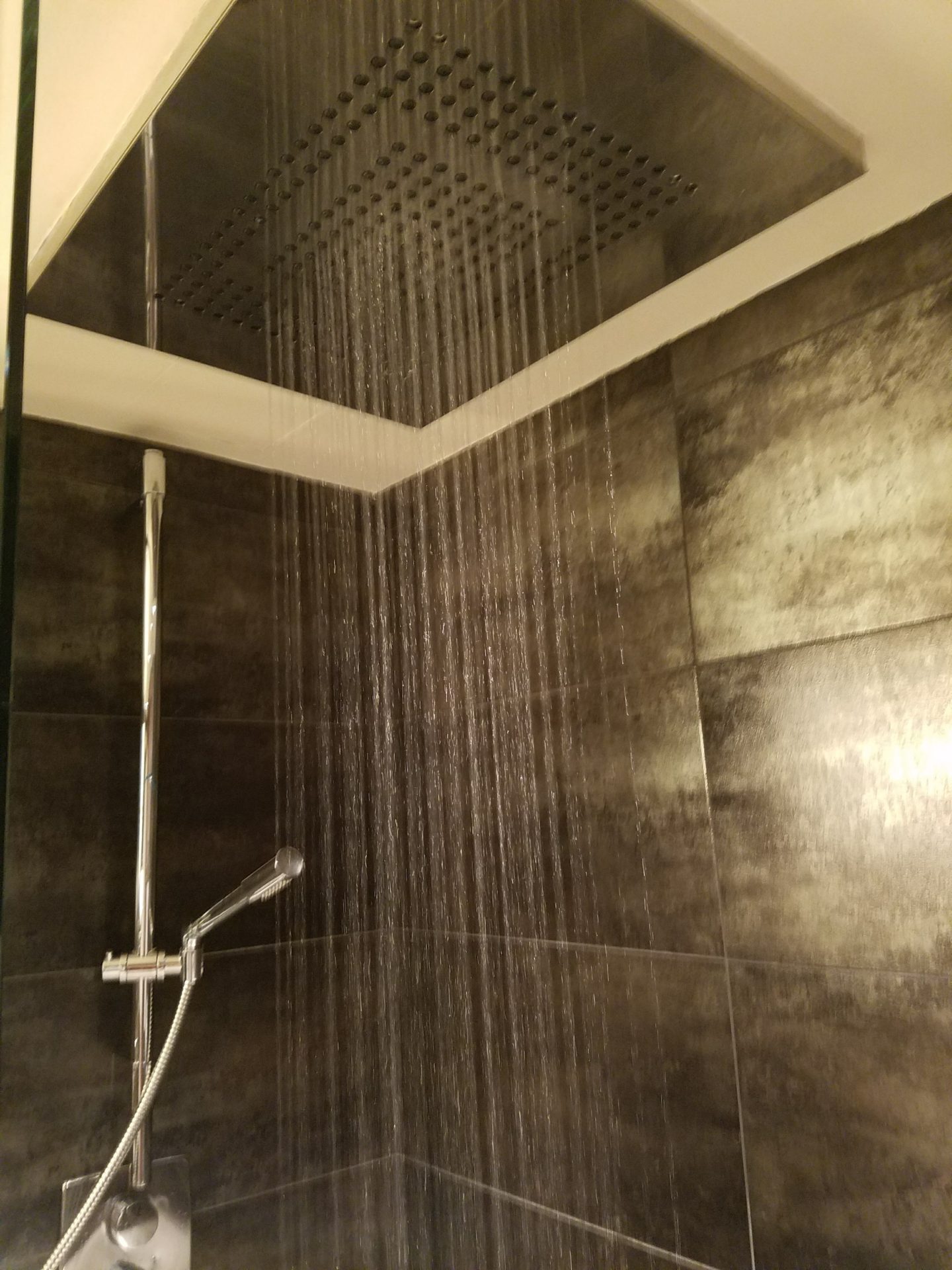 a shower with water running down the ceiling