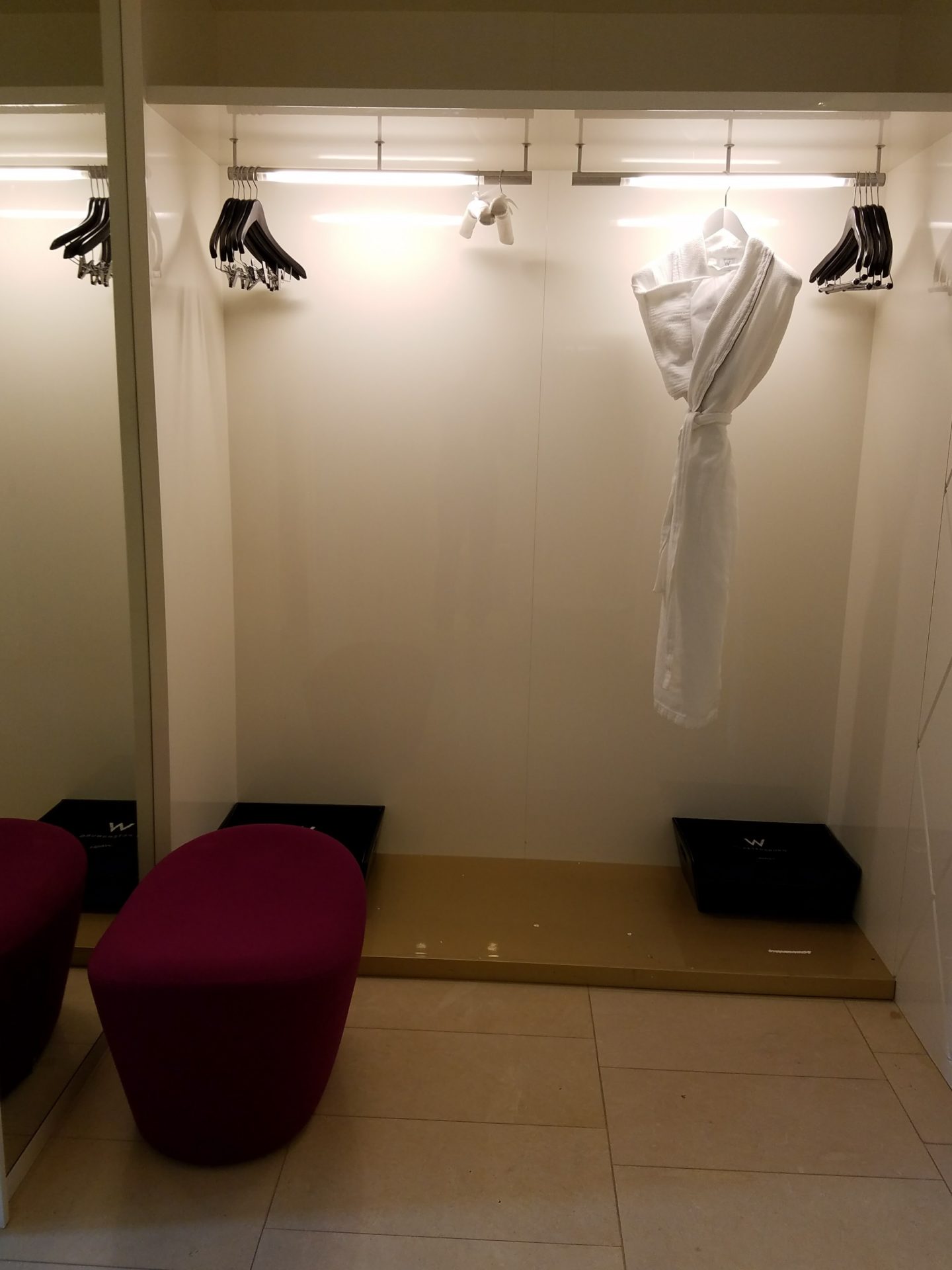 a white robe on a swinger in a dressing room