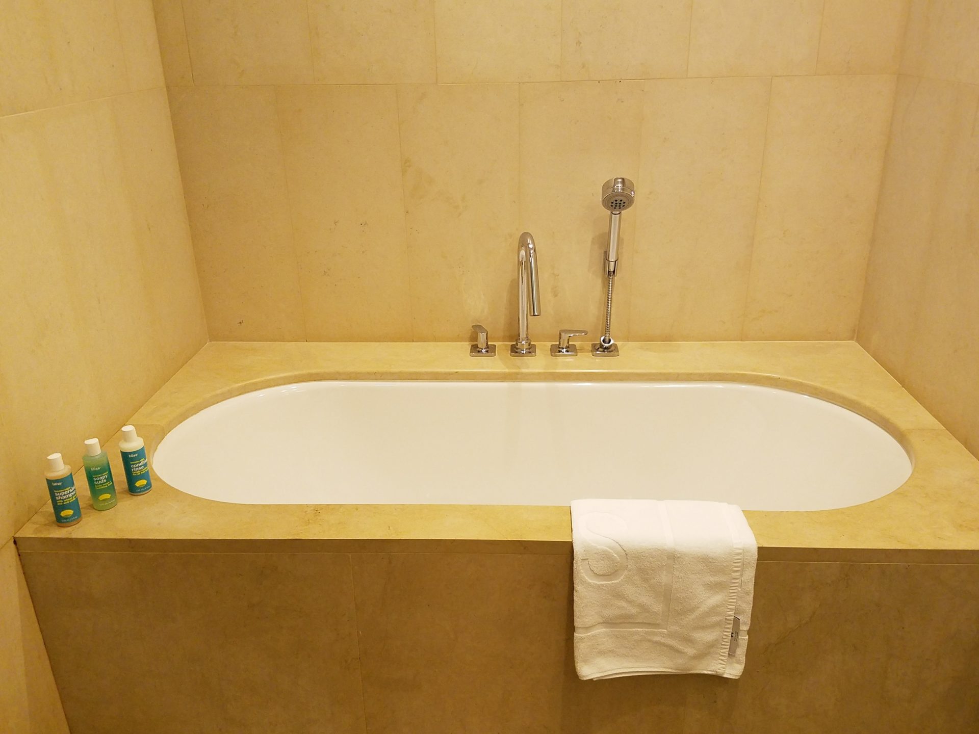 a bathtub with a towel and faucet