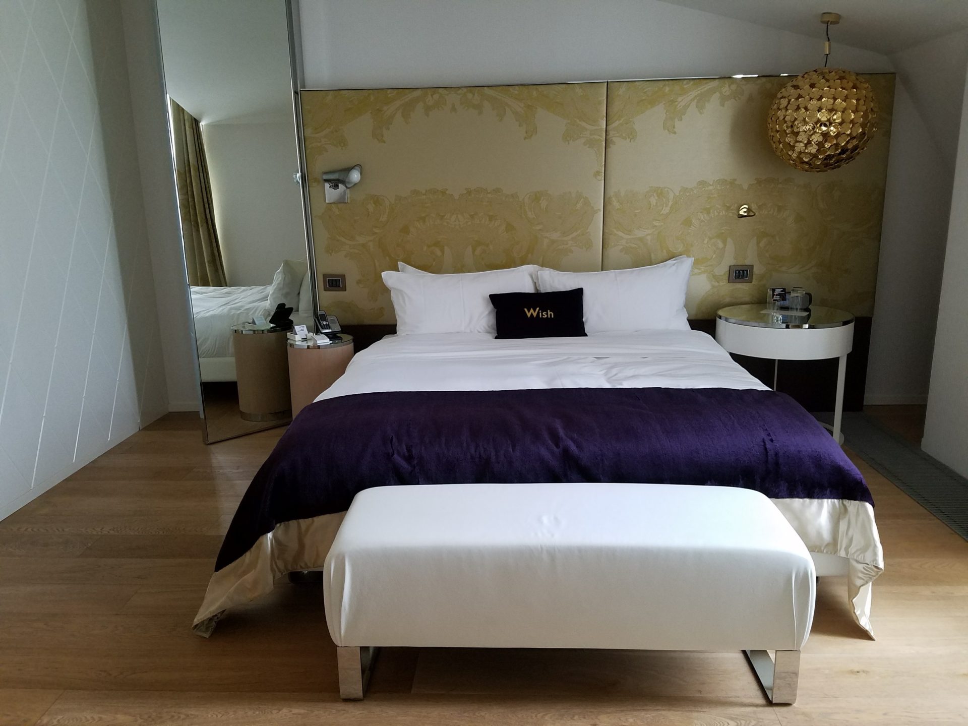 a bed with a mirror and a mirror above it