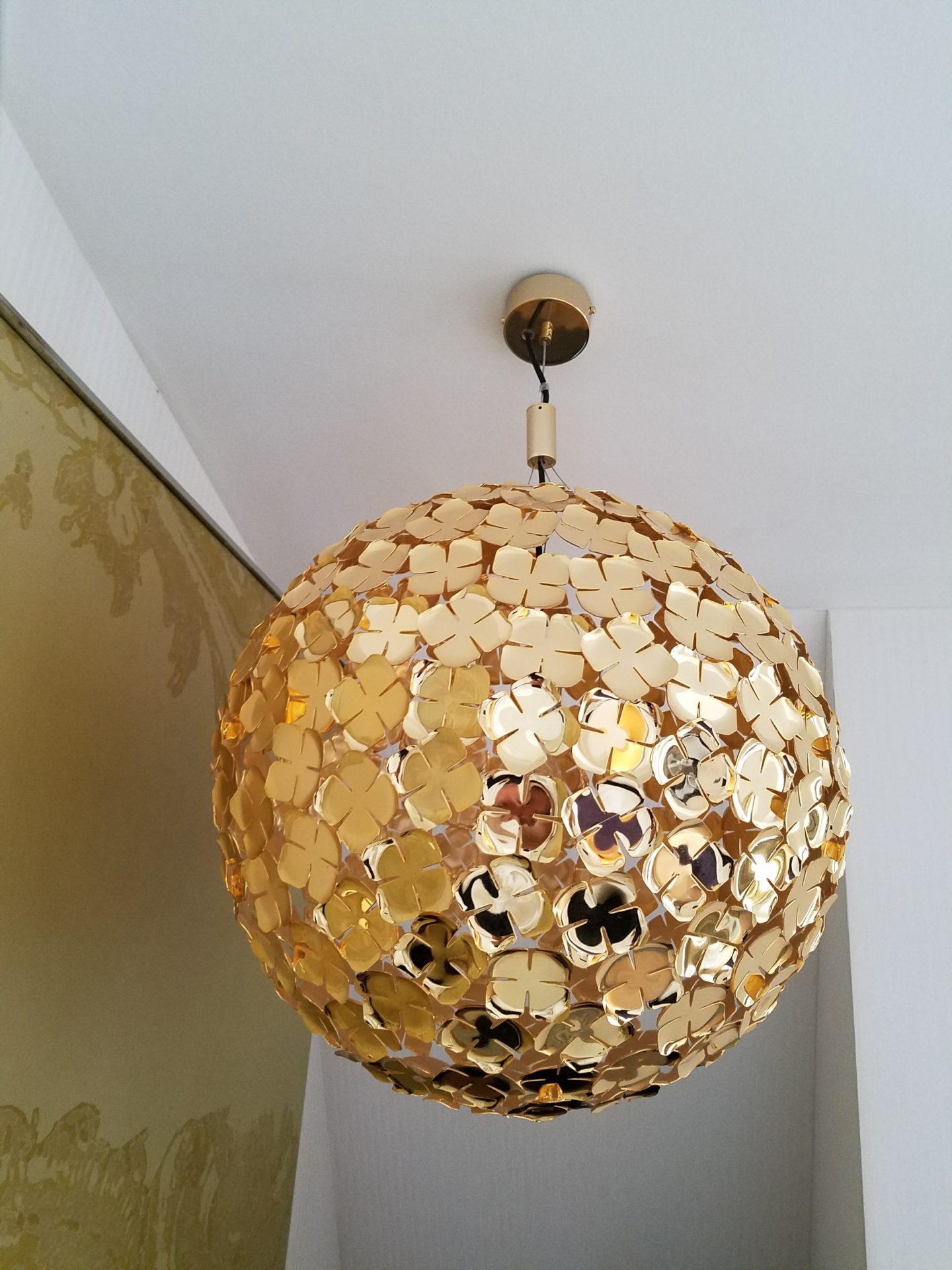 a gold ball with flowers on it