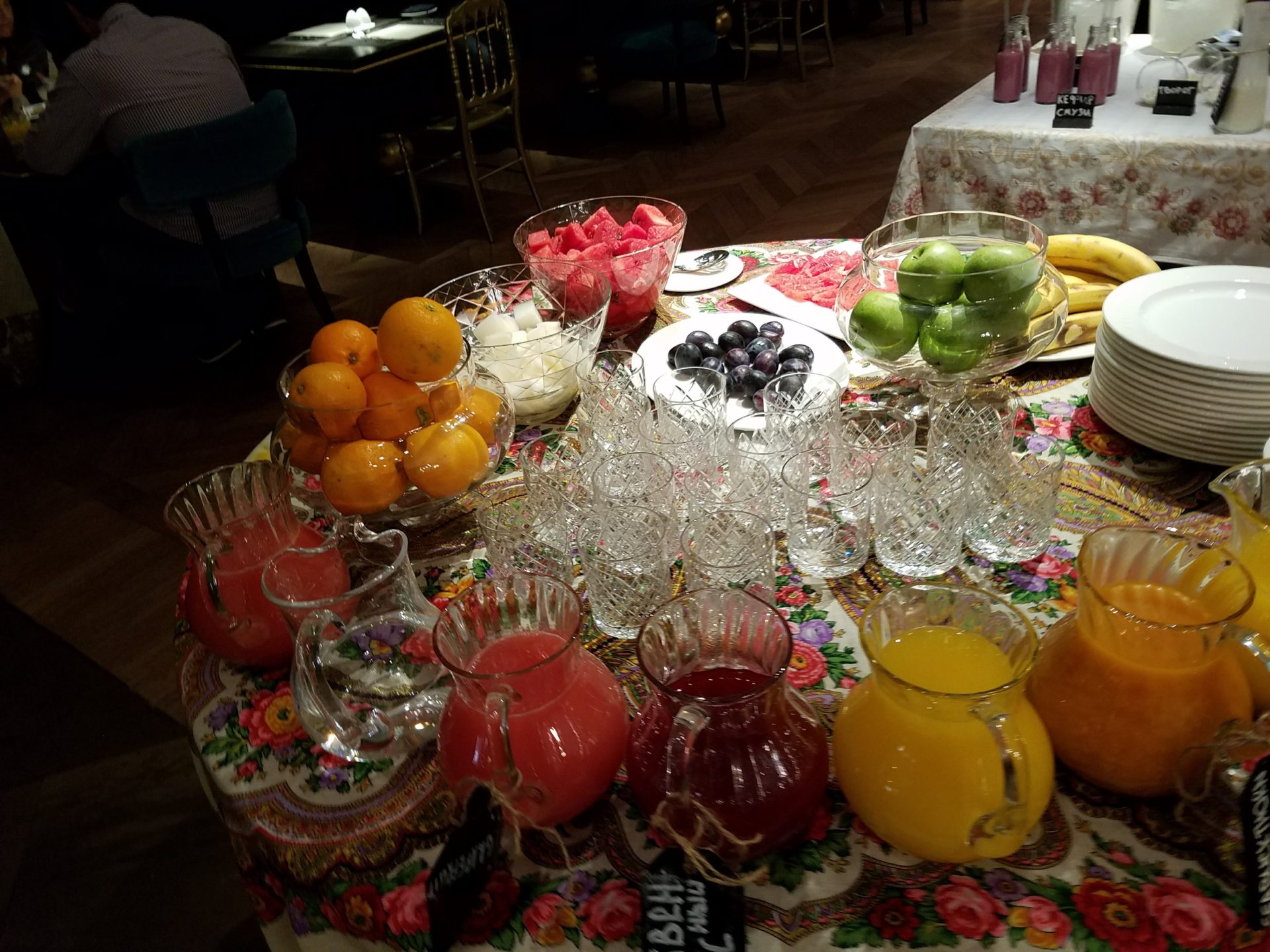 a table with fruit and juices
