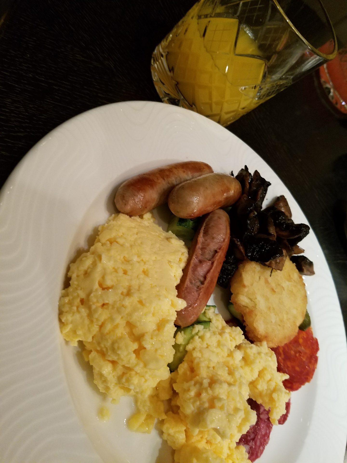 a plate of food and a glass of juice