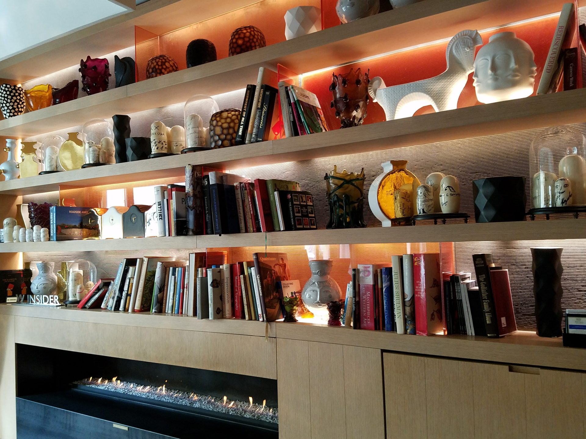 a shelf with books and candles