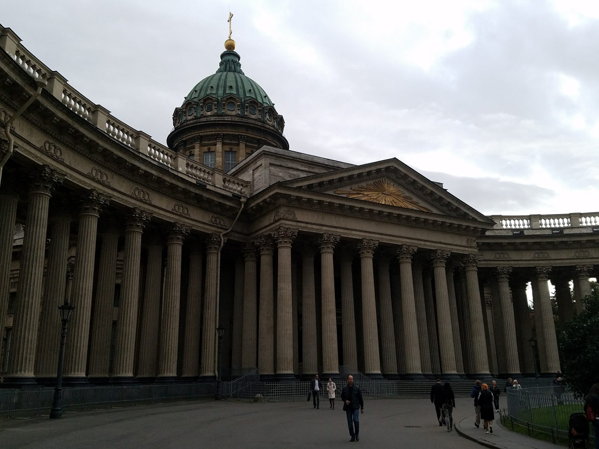 a large building with columns and a dome with Kazan Cathedral, Saint Petersburg in the background