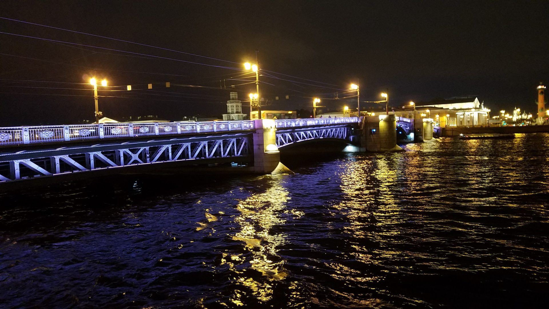 a bridge over water at night