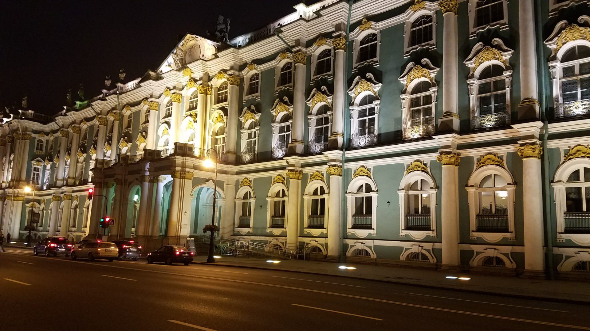 a building with many windows and a street at night