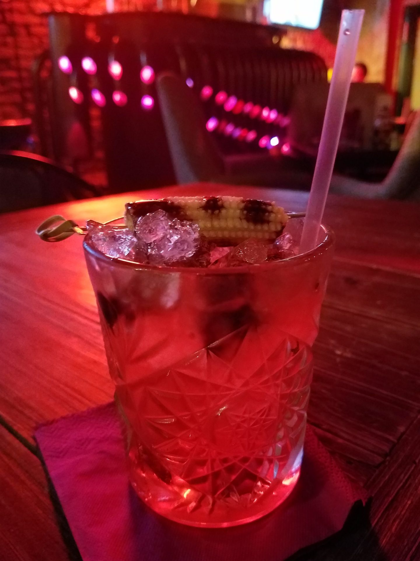 a glass with a drink and a straw