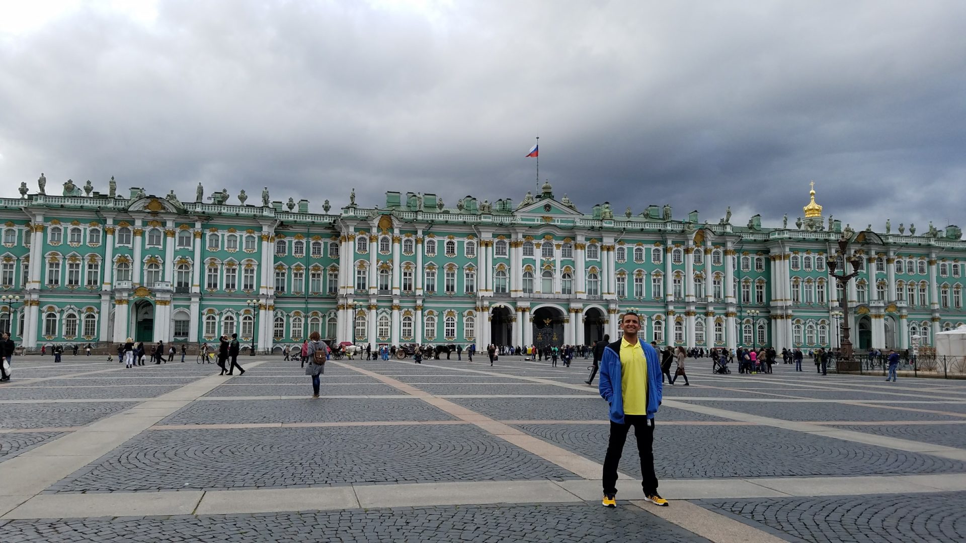 a man standing in front of a large building with Winter Palace in the background
