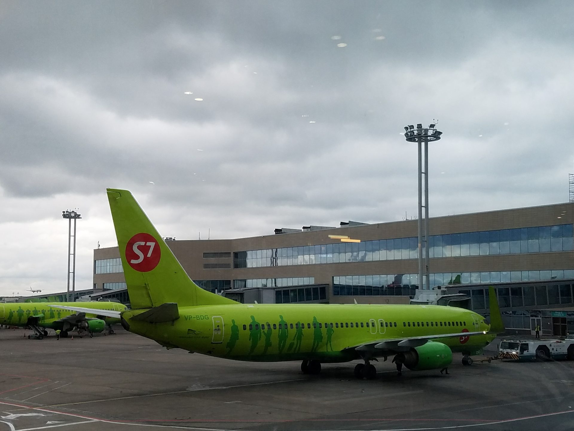 a green airplane on the tarmac