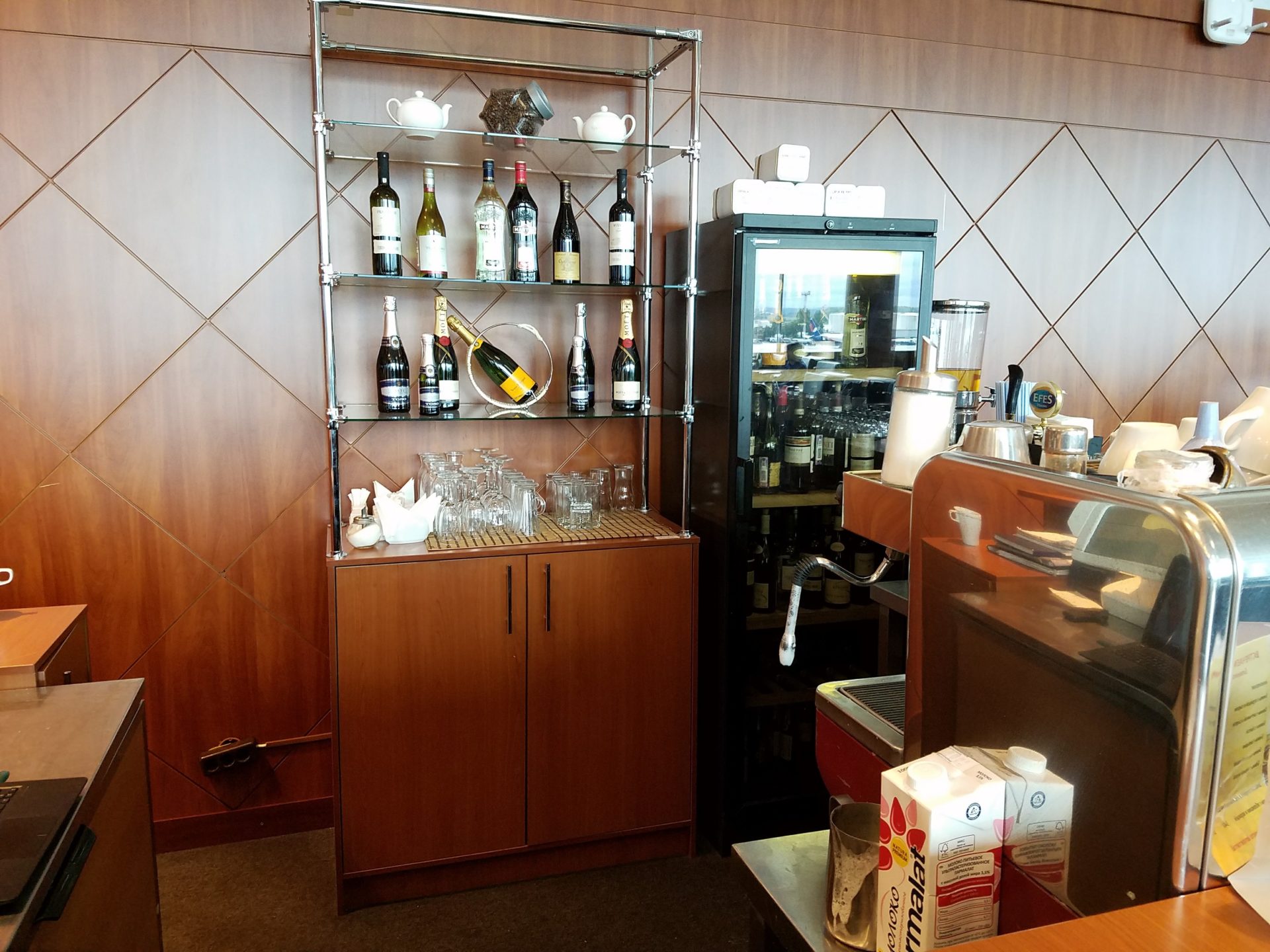 a bar with bottles of wine and glasses