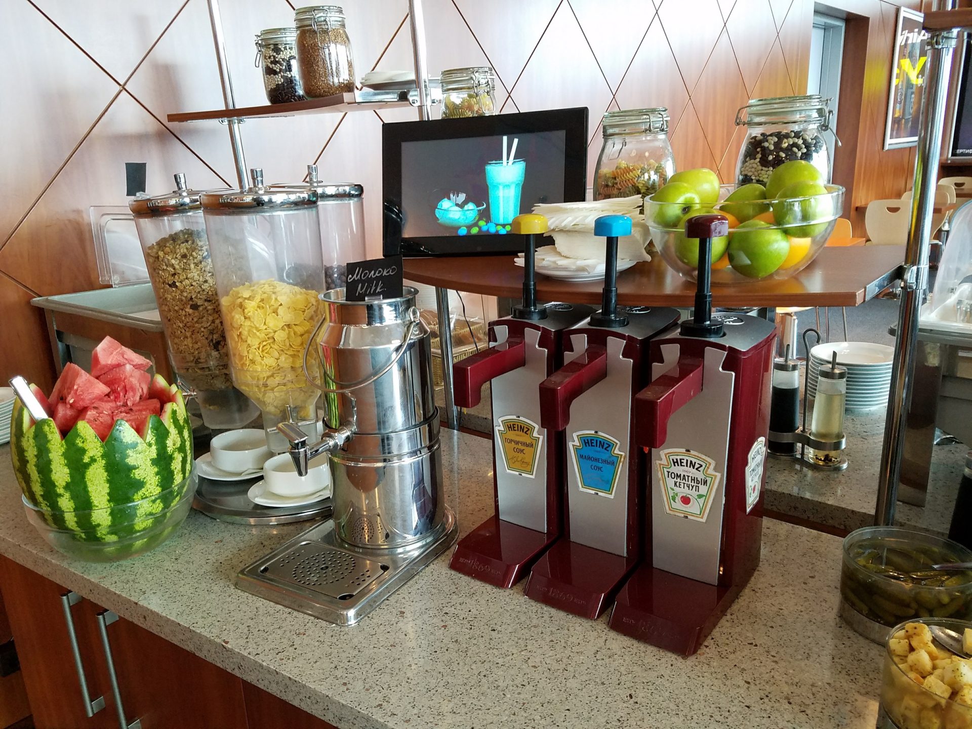 a counter with fruit and juice dispensers