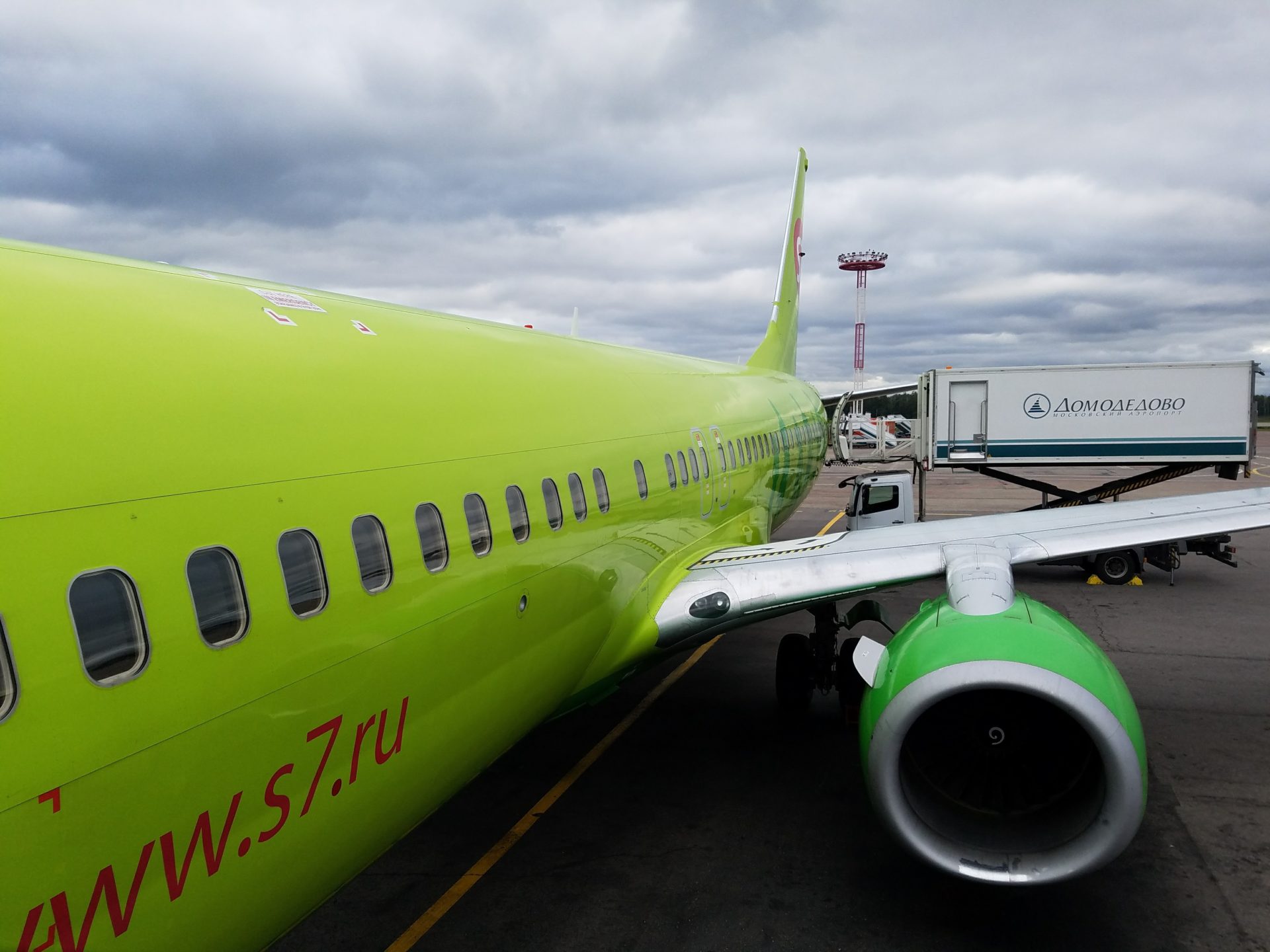 a green airplane on a runway