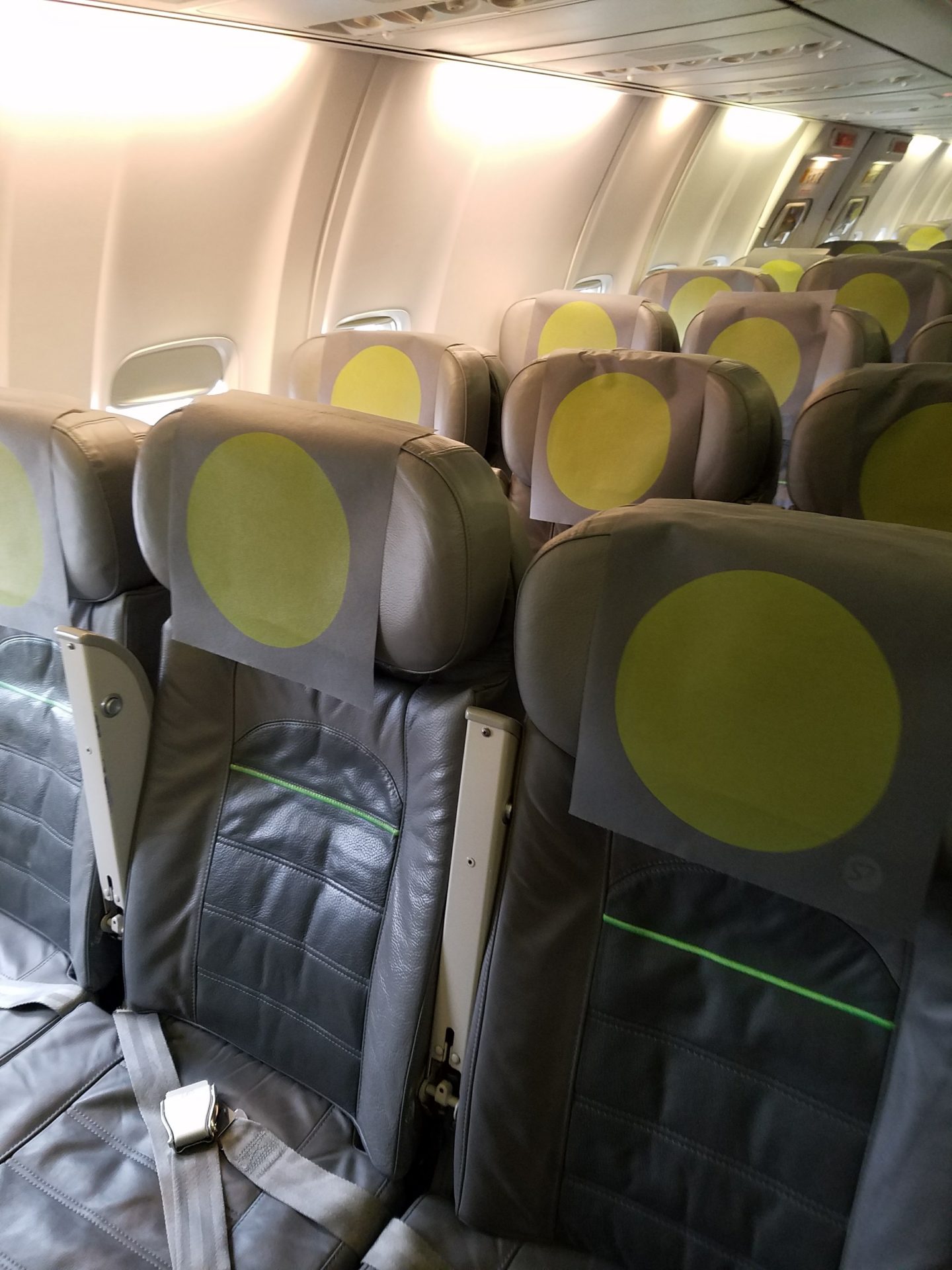 a row of seats with yellow circles on them