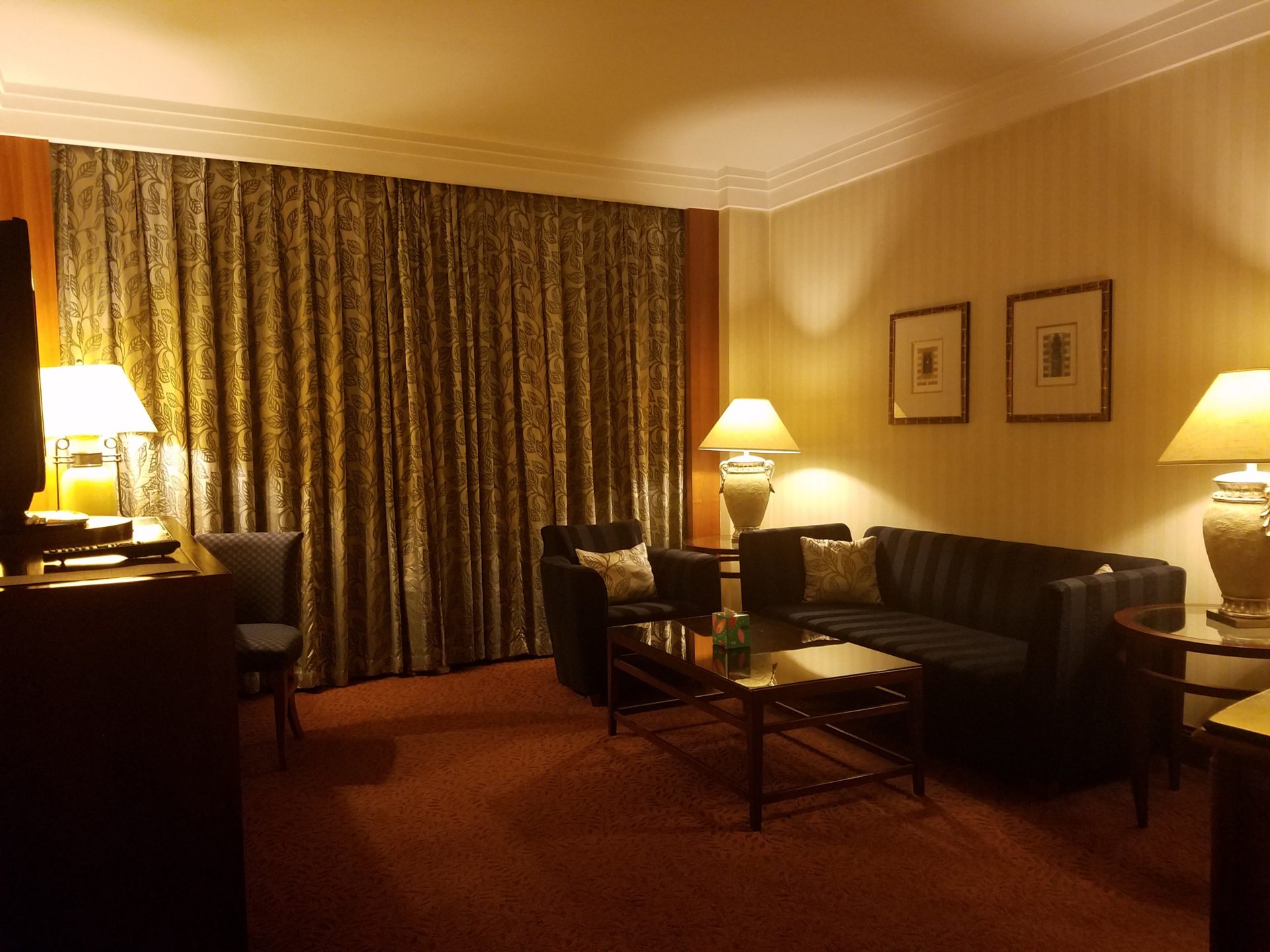 a room with a couch and a table and lamp