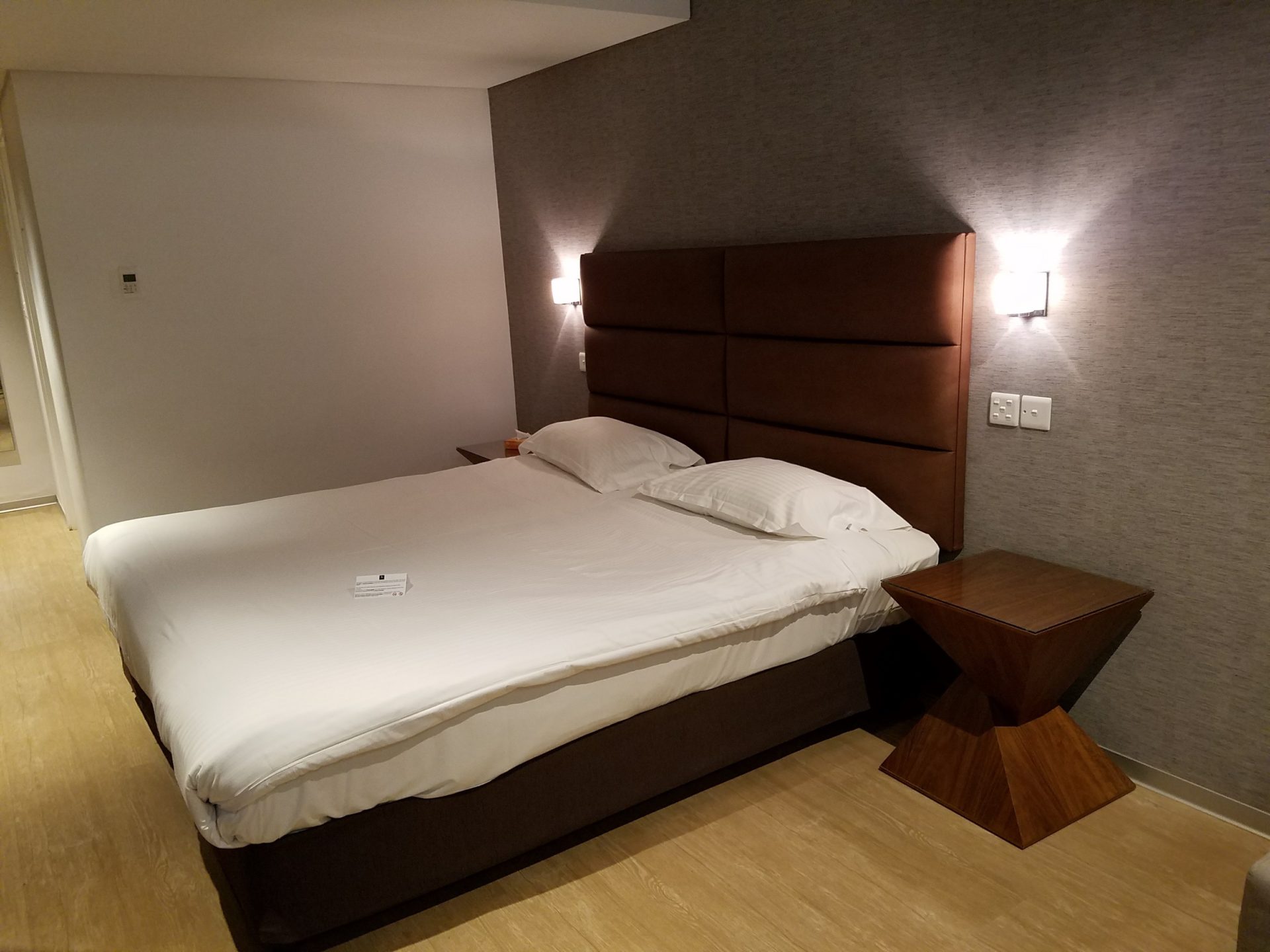 a bed with a headboard and a table