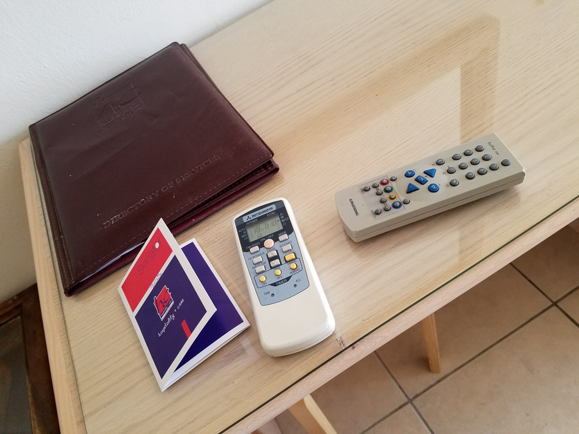 a remote control and a wallet on a table