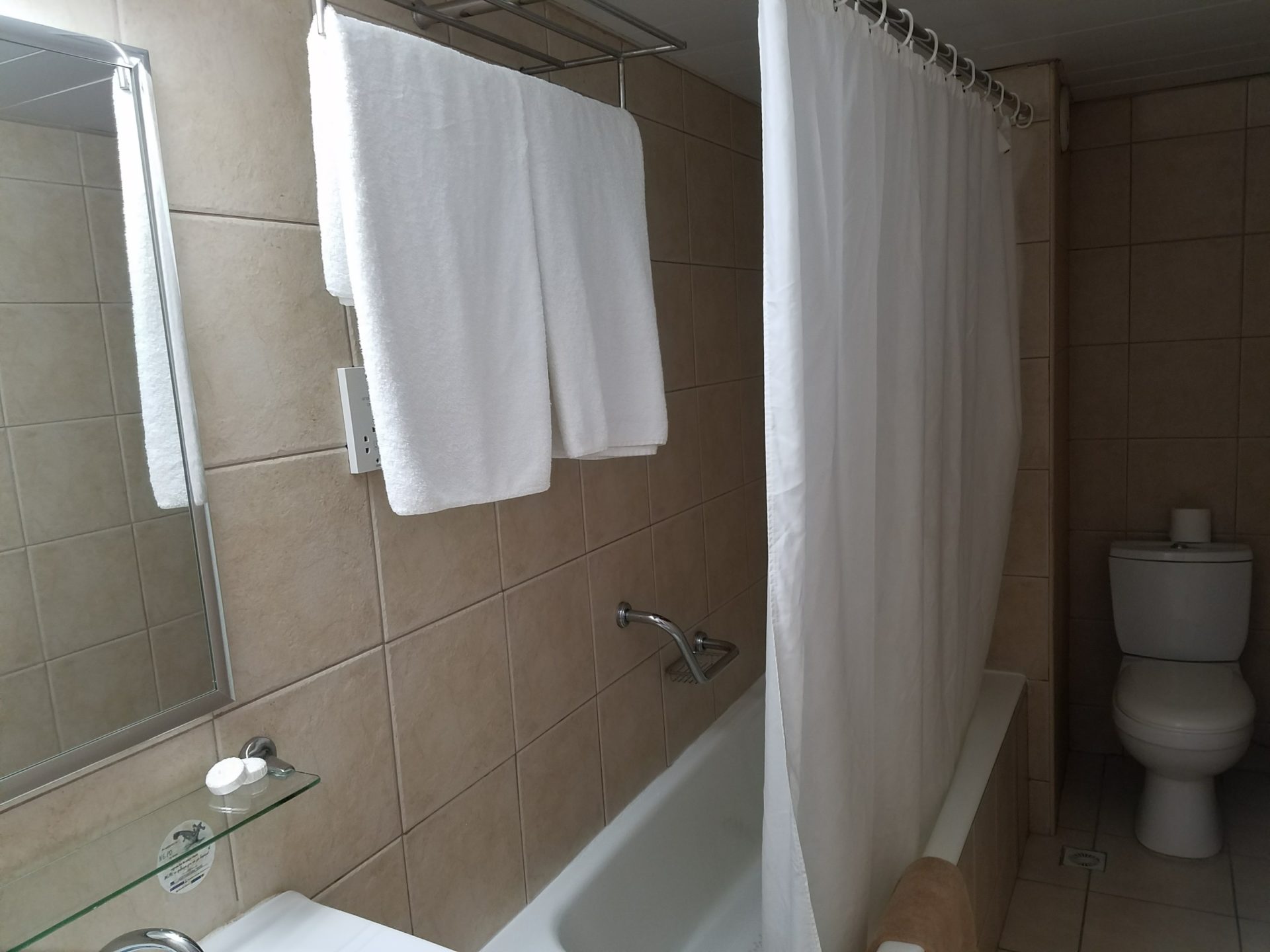 a bathroom with white towels and a bathtub