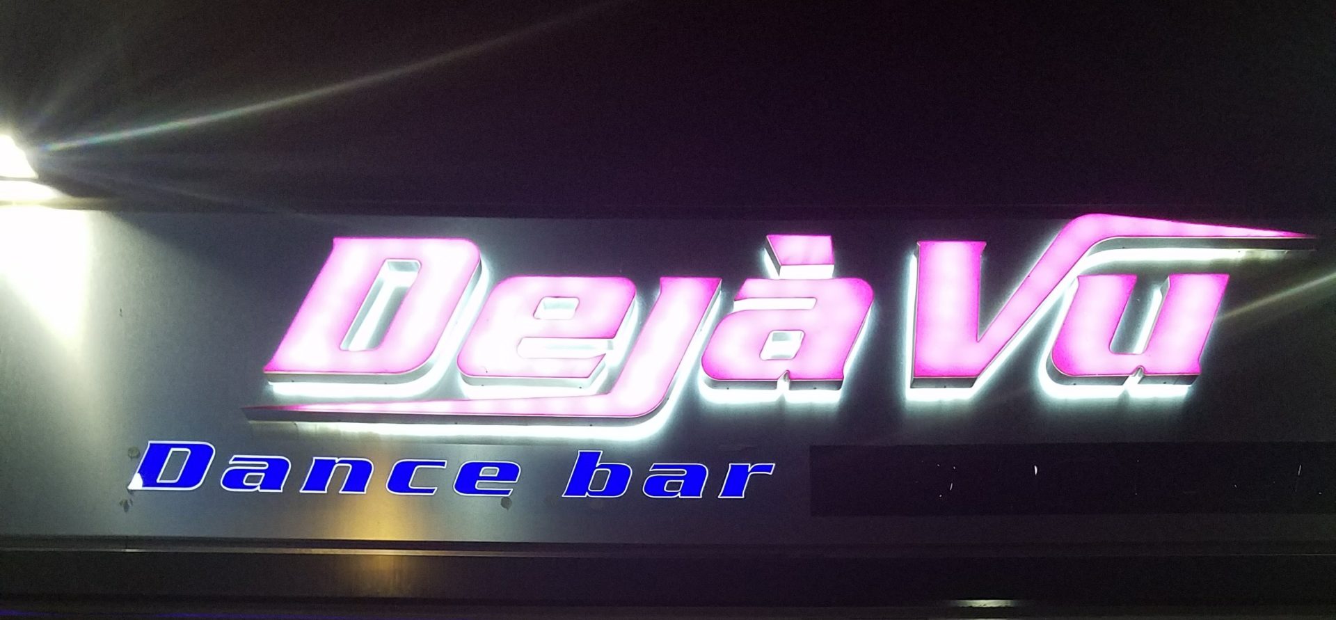 a sign with a lit up sign