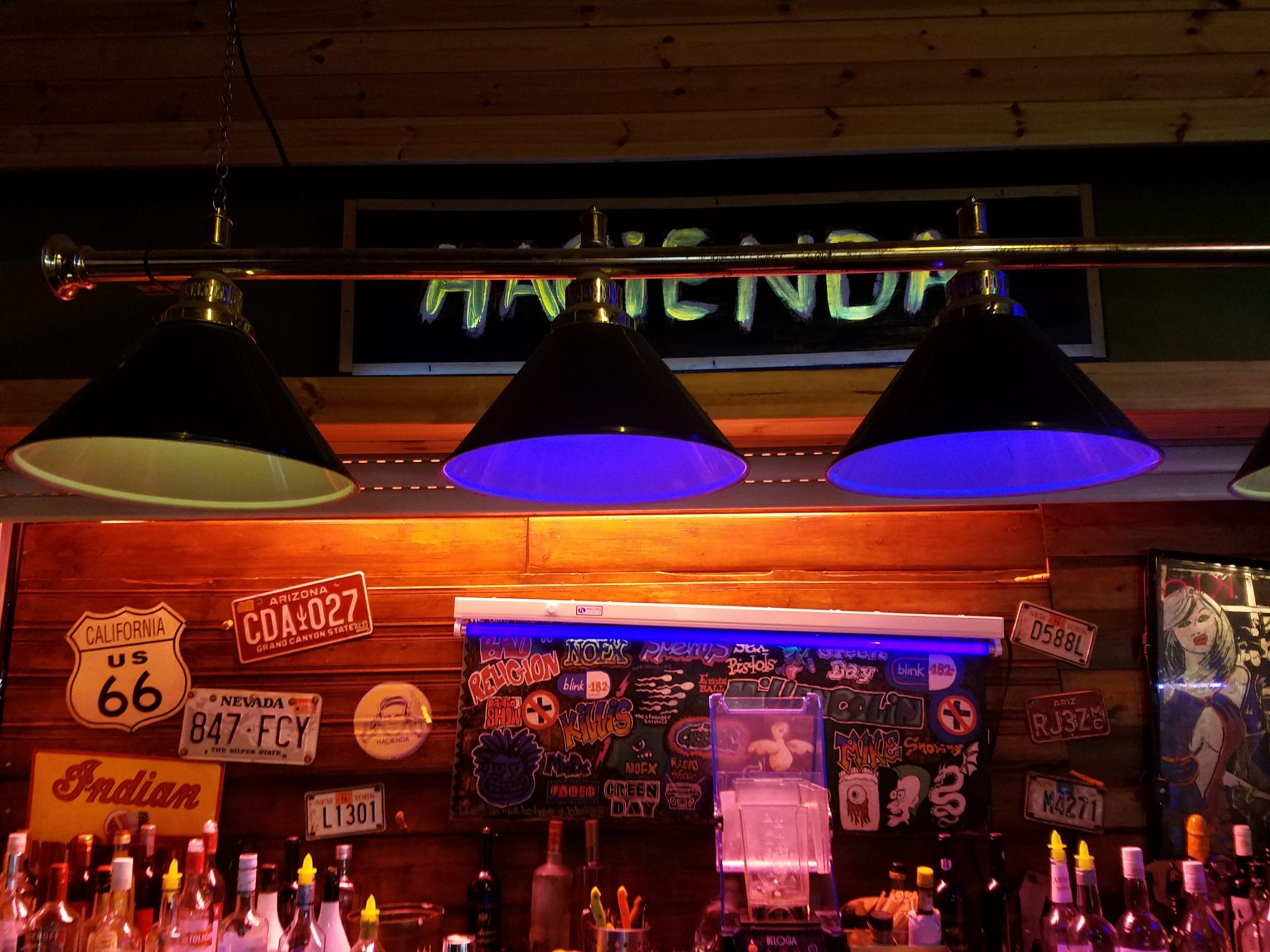 a bar with lights and a sign
