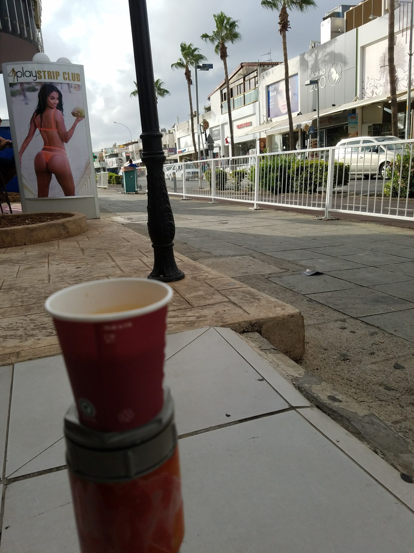 a cup on a sidewalk